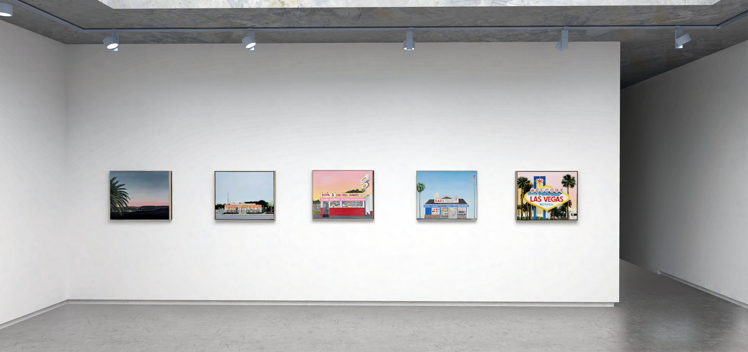 Five framed photographs or artworks displayed in a row on a white gallery wall, featuring scenes of Nevada, including Las Vegas signage and desert landscapes.