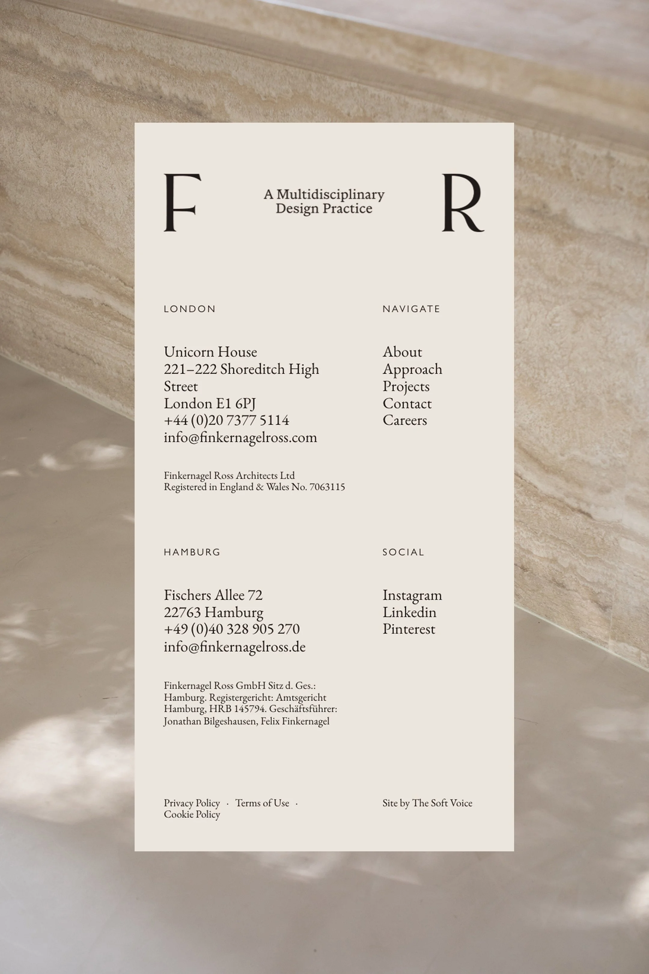 A contact information card for Finkernagel Ross Architects Ltd, including address, phone numbers, email, and social media links, placed on a marble surface.