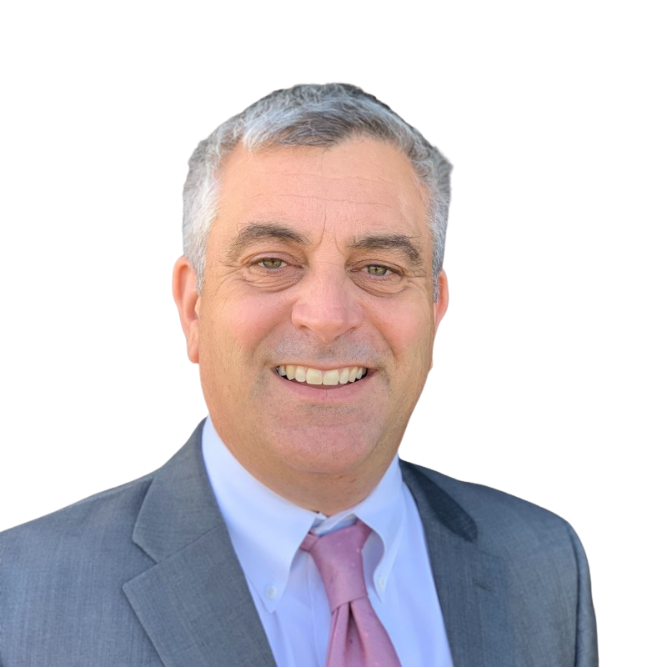 Professional portrait of a middle-aged man with short gray hair wearing a gray suit, white shirt, and pink tie, smiling with teeth showing.