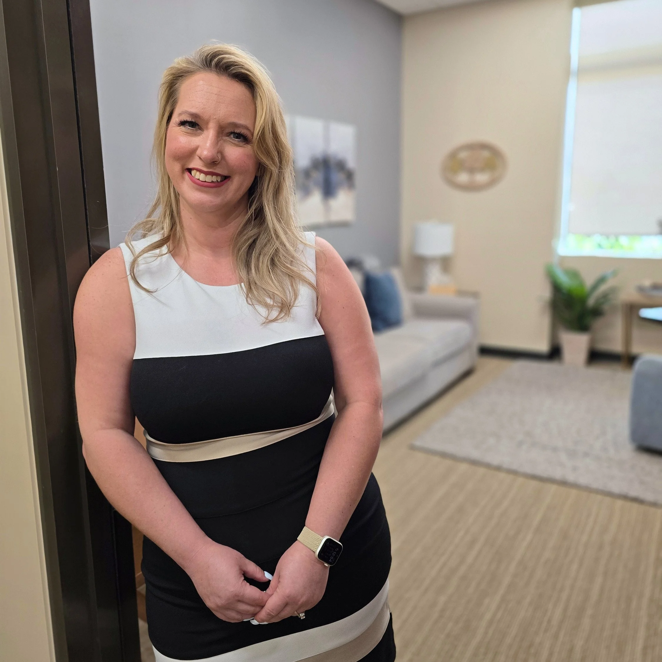 Rachael stands in the doorway to greet clients