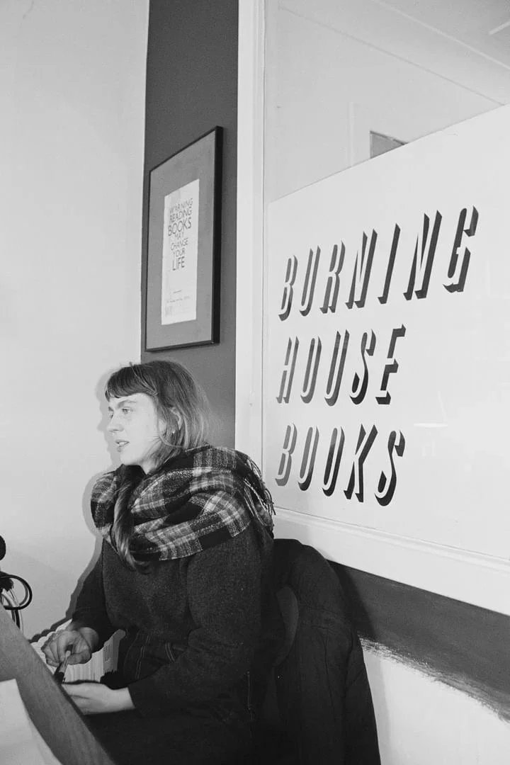 Black and white portrait of Aimee in her bookshop 'Burning House Books' by Meg Auld