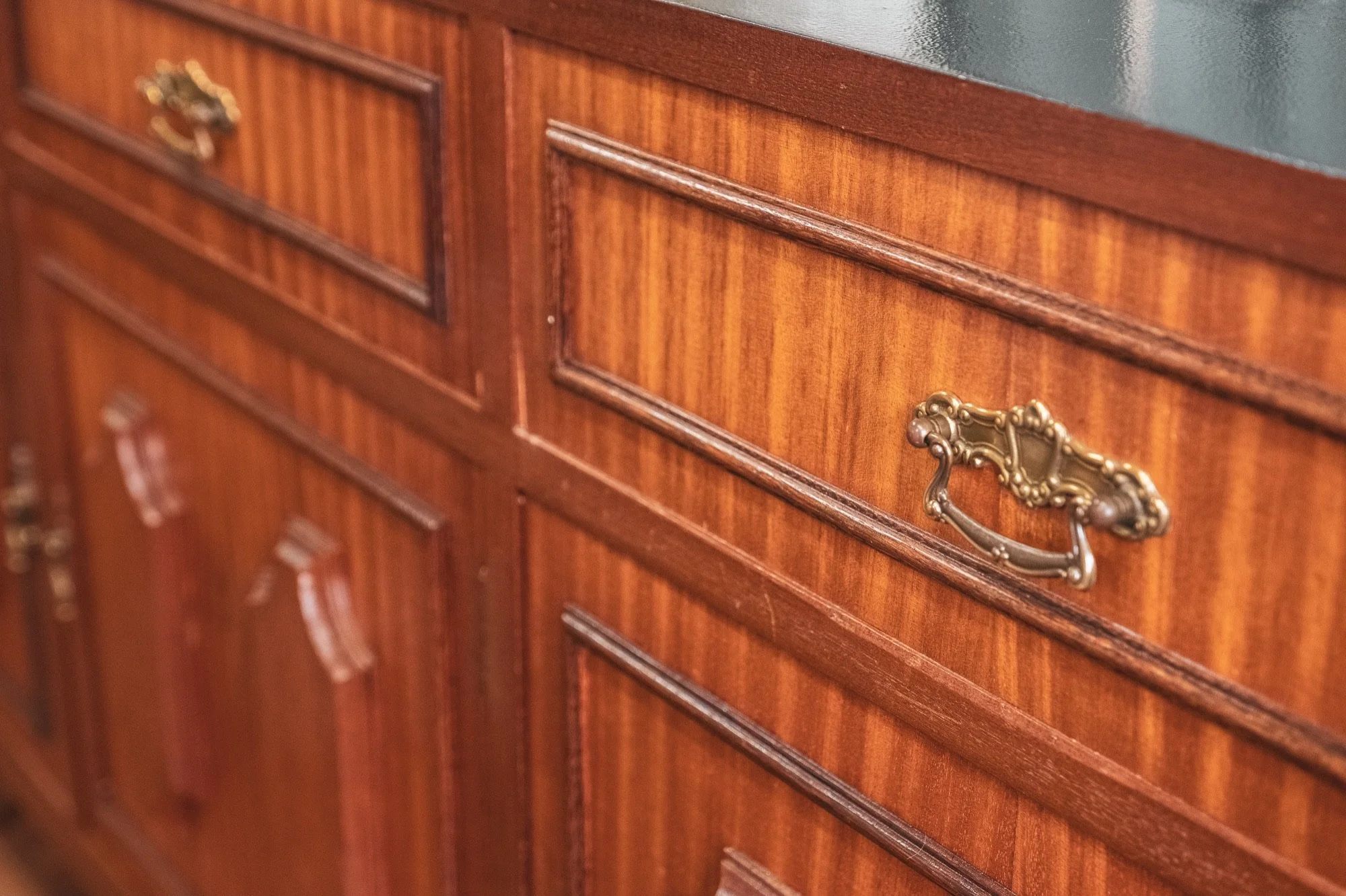 Reclaimed vintage wooden cabinet with brass handles at Minds & More hair studio, Lisbon