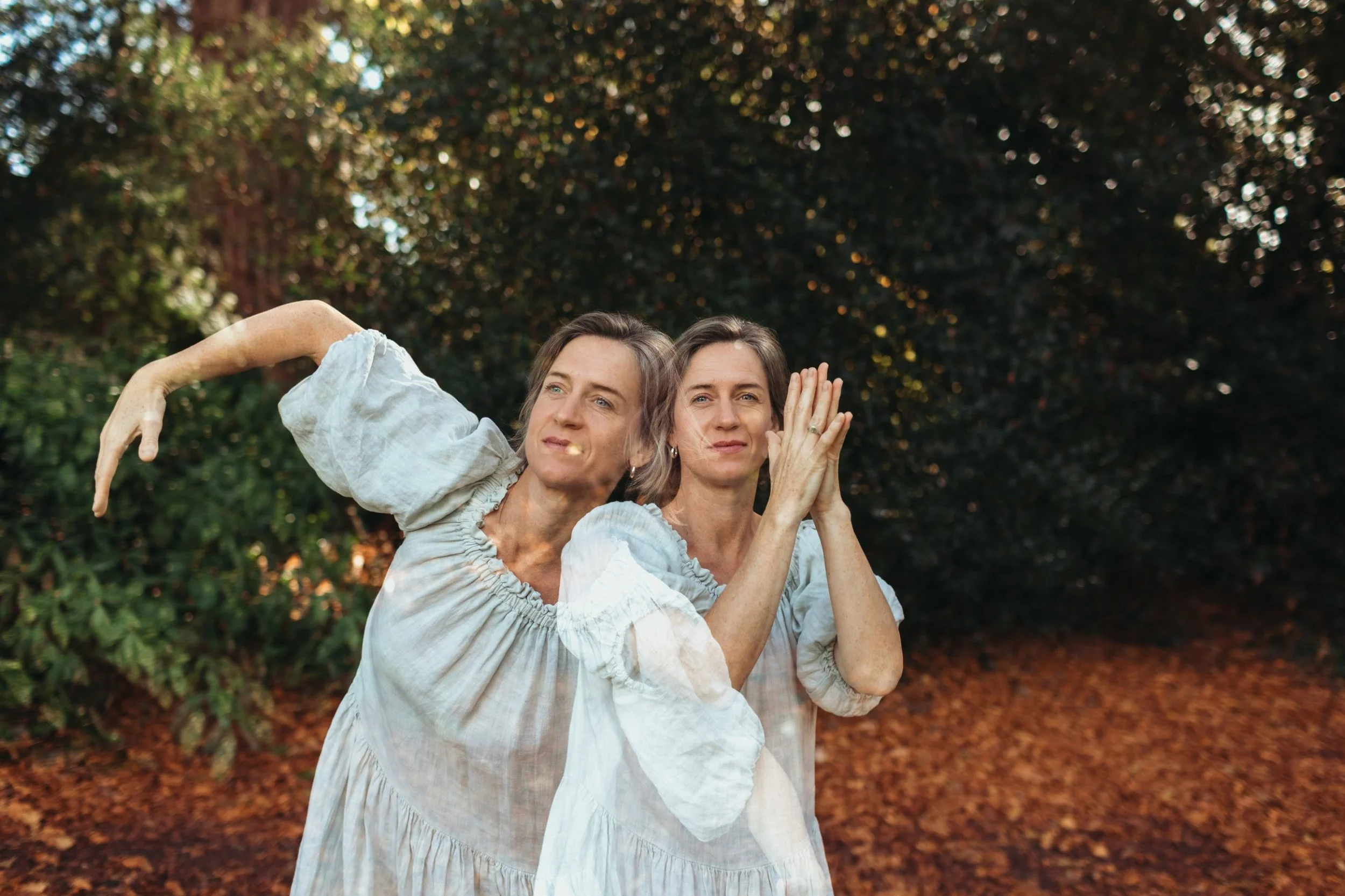 Holly Warren in a linen dress flowing through a yoga movement among autumn leaves, shown as a double exposure