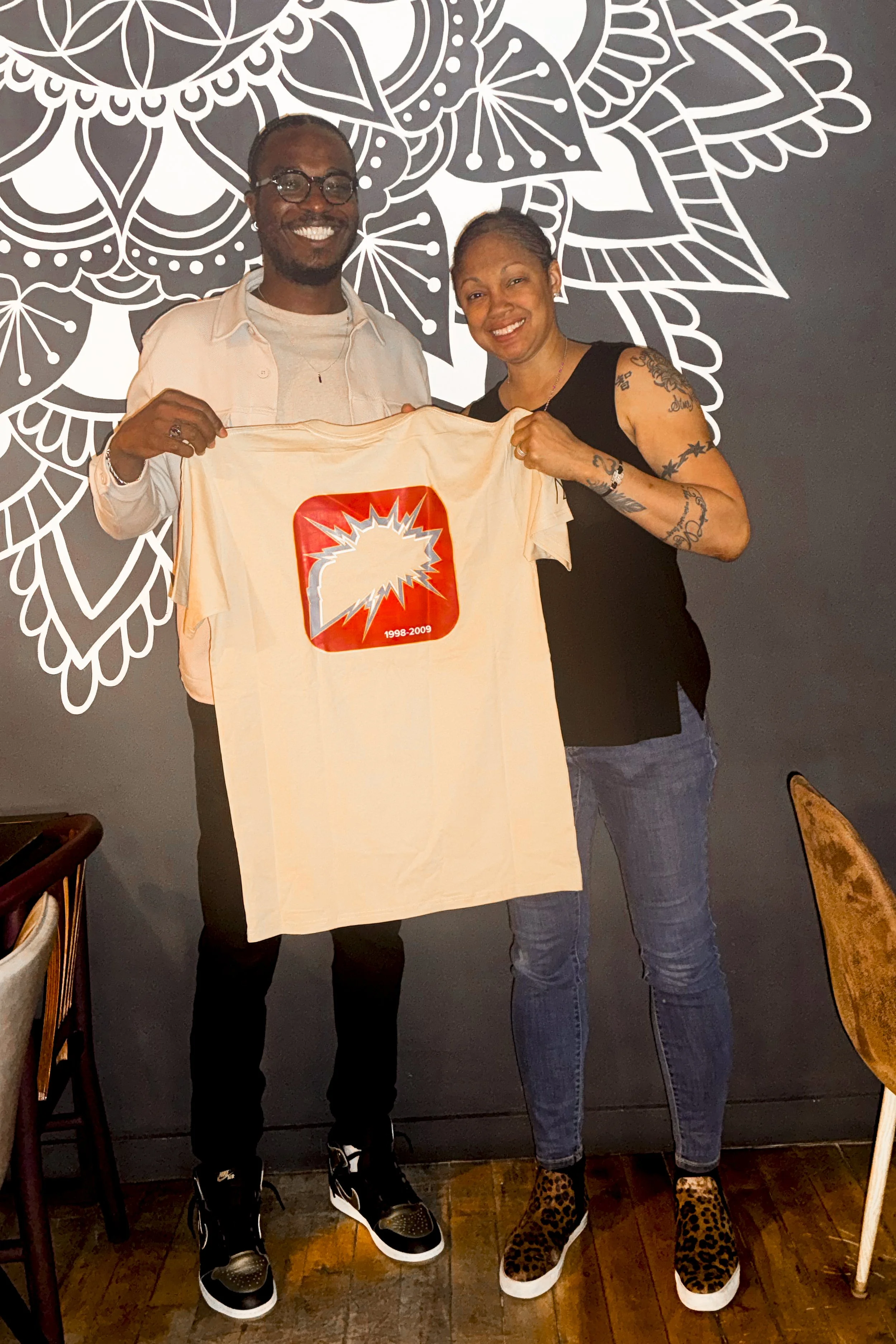 Writer/director Larry J. Sanders holding SHOCKWAVE t-shirt with Detroit Shock legend Deanna Nolan