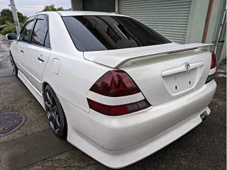Classic JDM car exterior with clean body lines and factory aero kit