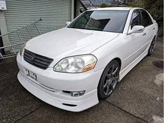 Classic JDM car exterior with clean body lines and factory aero kit