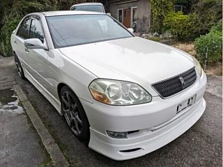 Classic JDM car exterior with clean body lines and factory aero kit