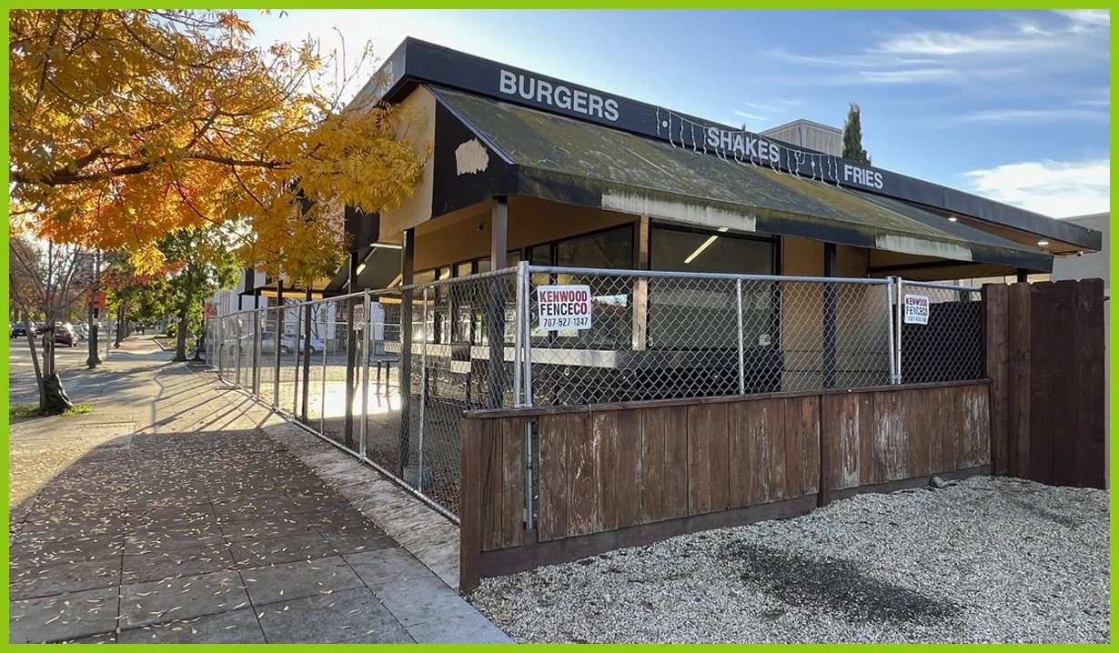  A pretty park offers hope, but across from it, a grill with a collapsing awning sits fenced off. 