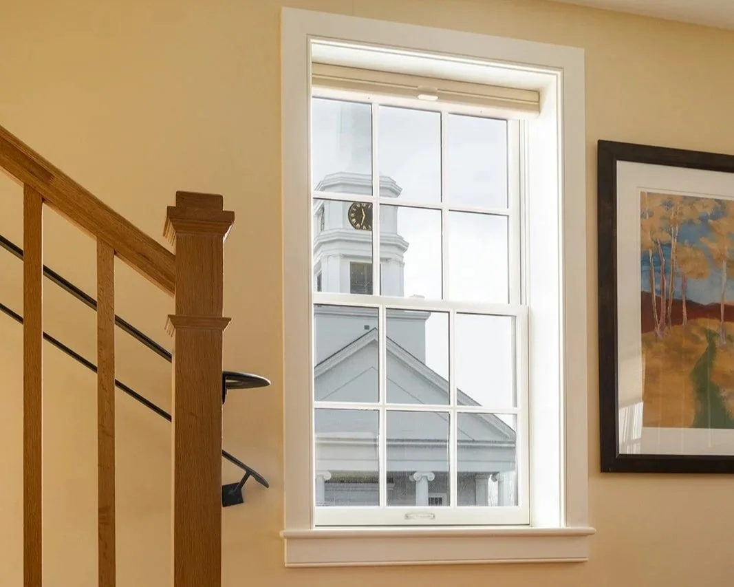 Private staircase in Orion's Retreat leading to upper level with window view of Stowe Community Church steeple