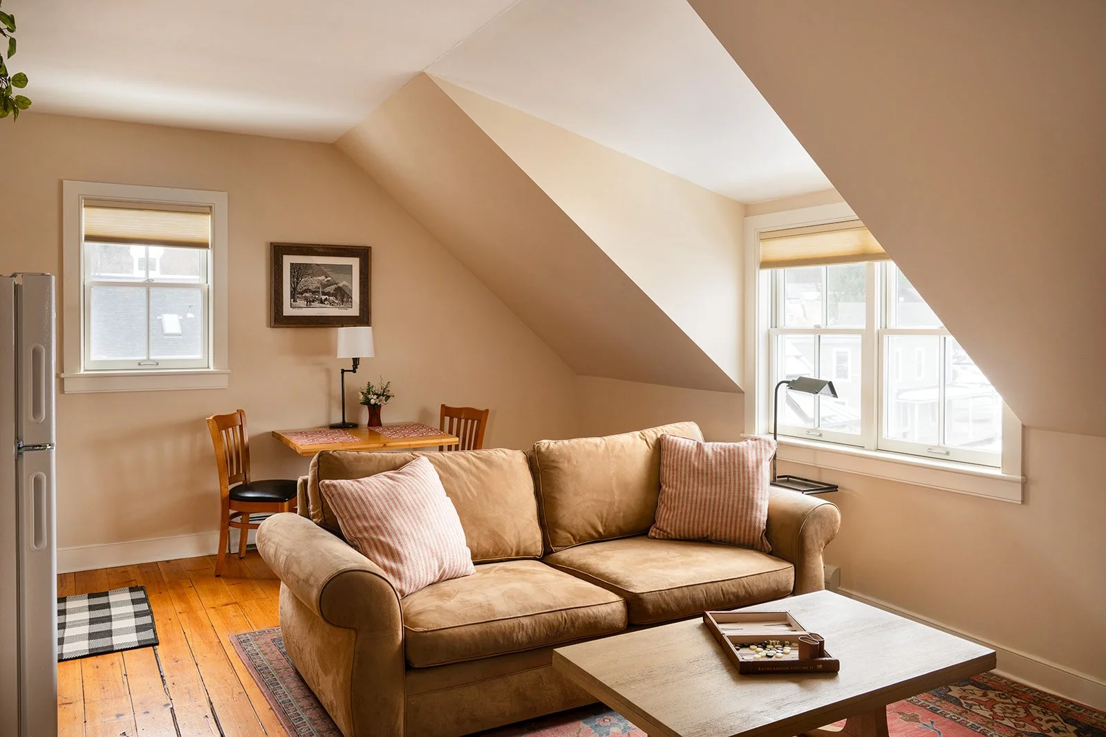 Butler's Hideaway suite in Stowe VT with warm natural light, comfortable sofa and quiet residential feel