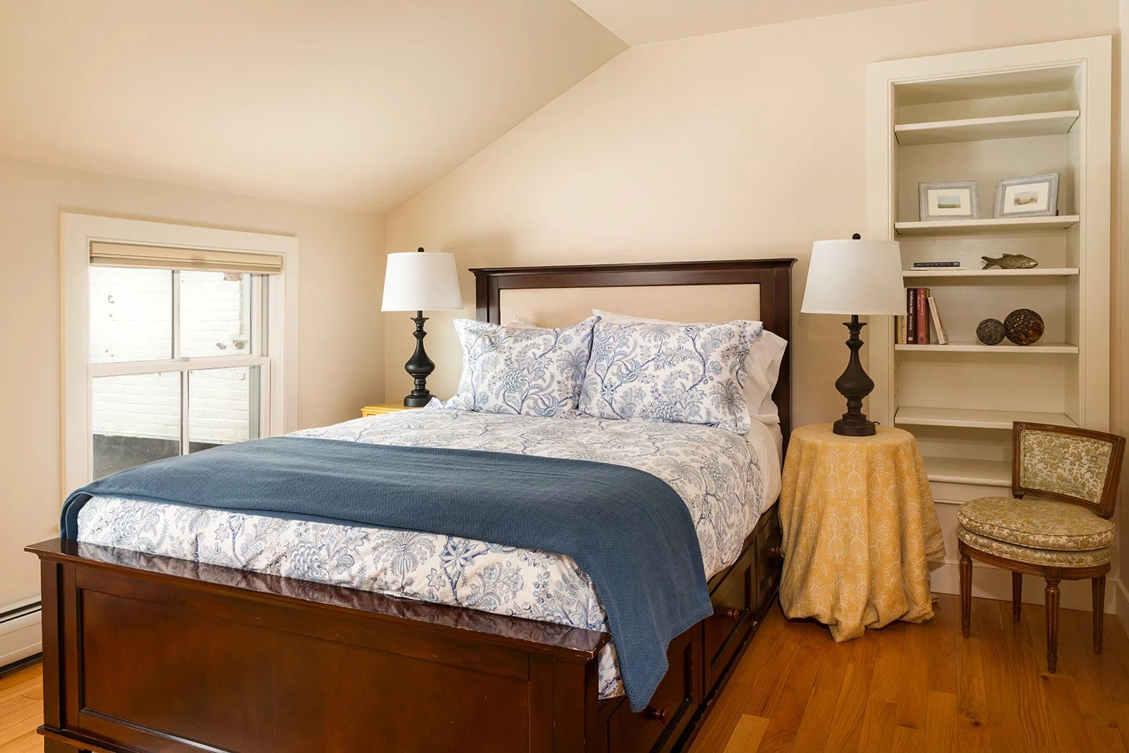 Private queen bedroom in Max's Roost with hardwood floors, soft lighting and classic New England Style