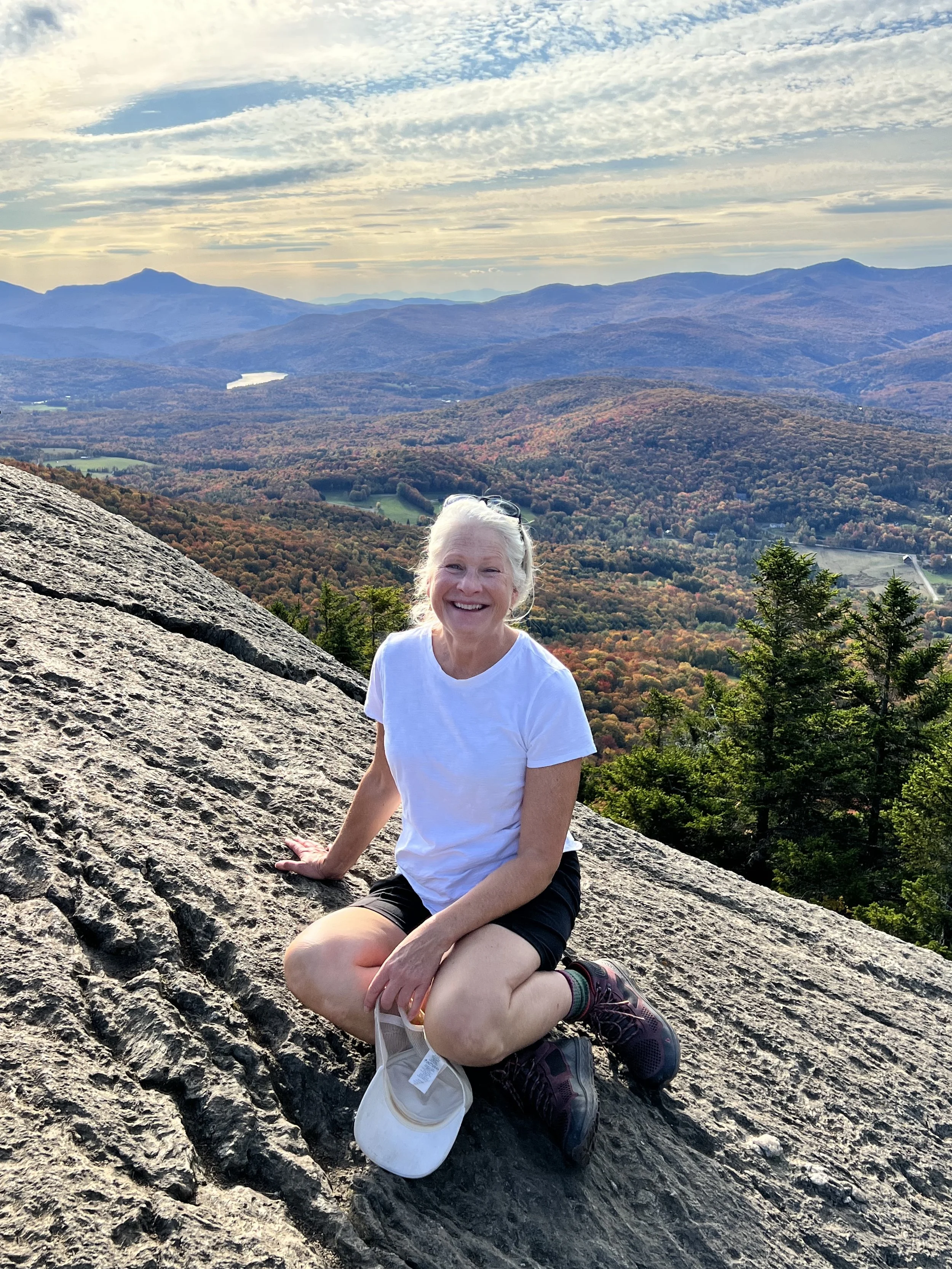 Hiking in Stowe Vermont with panoramic mountain views and fall foliage from scenic mountain overlook