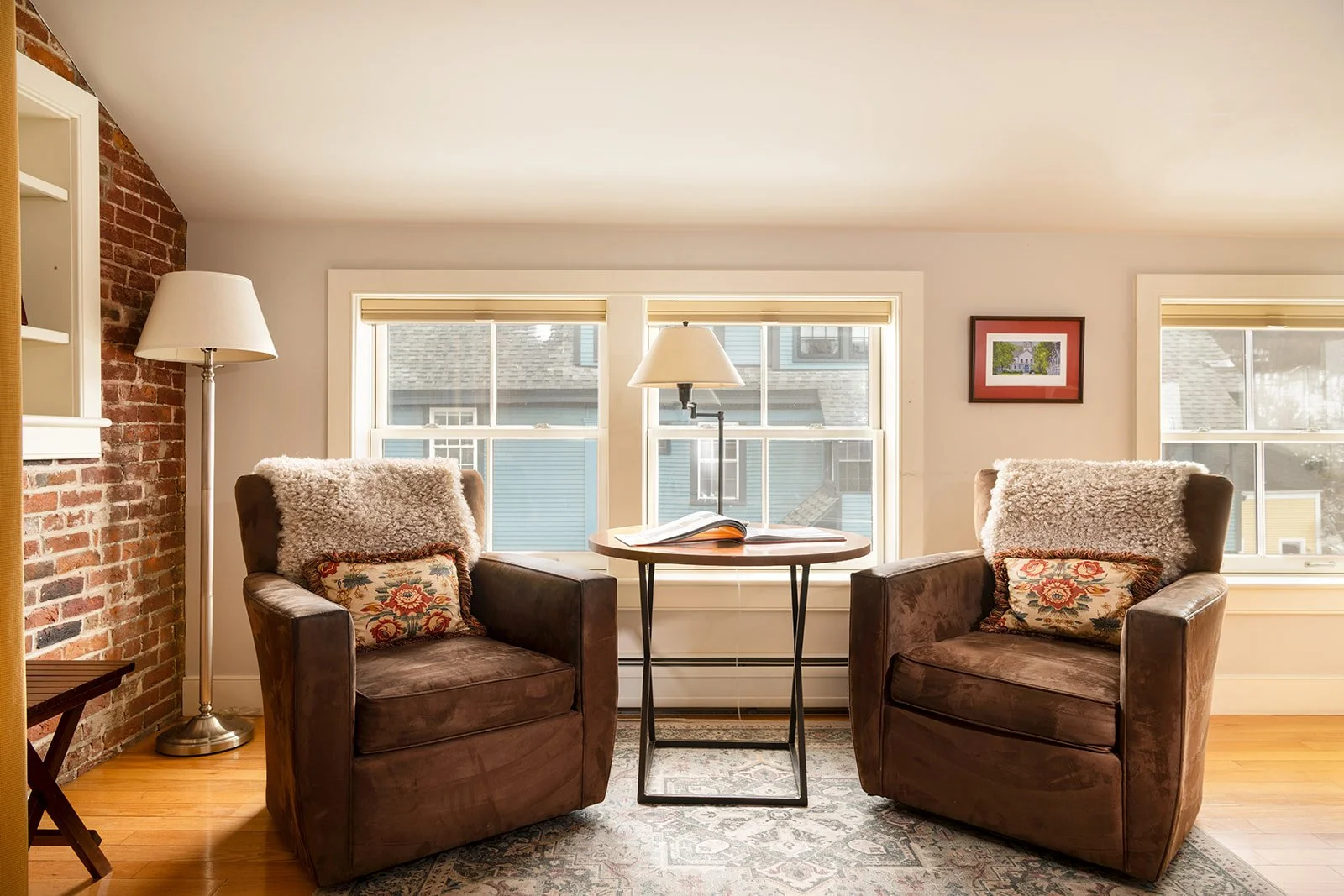 Cozy seating area in Murphy's Studio with armchairs, small table and views of Stowe Village