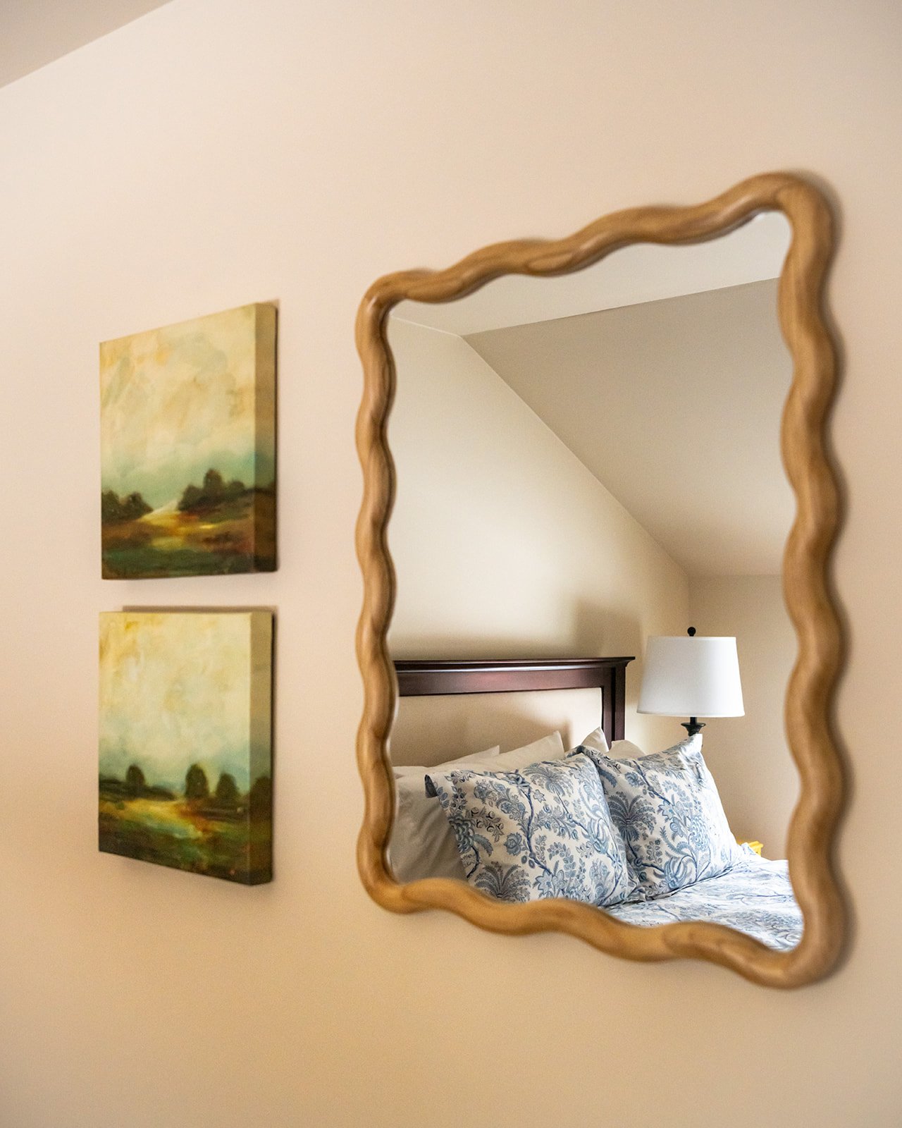 Bedroom detail in Max's Roost featuring cozy bedding, bedside lamps and warm, inviting design