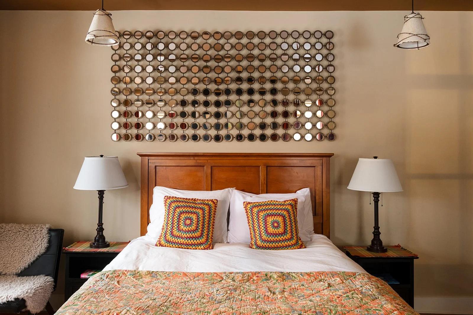 Queen bed in The Lounge Stowe Vermont with colorful textiles and classic New England decor