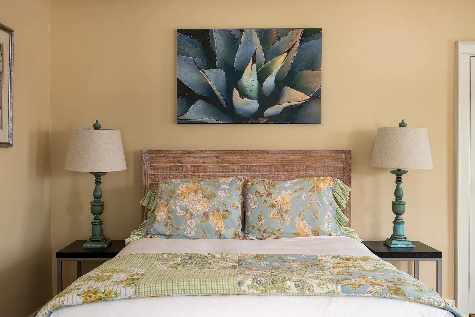 Queen size bed in Parlor Suite at Butler House with soft linens and classic New England decor
