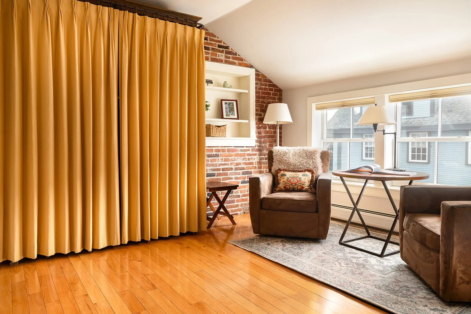 Historic Brick alcove studio in Murphy's Studio Stowe VT with curtain divider, sitting area and natural light