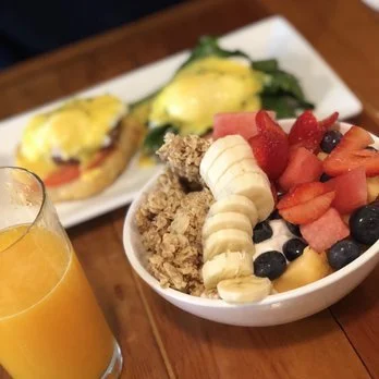Breakfast at Butler's Pantry in Stowe Vermont featuring fresh fruit yogurt bowl and eggs benedict with orange juice