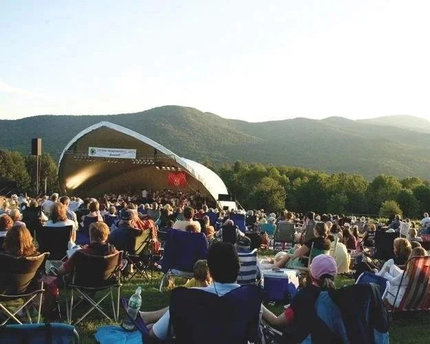 Outdoor concert at Stowe Performing Arts in Vermont with audience seated and mountain views in the background