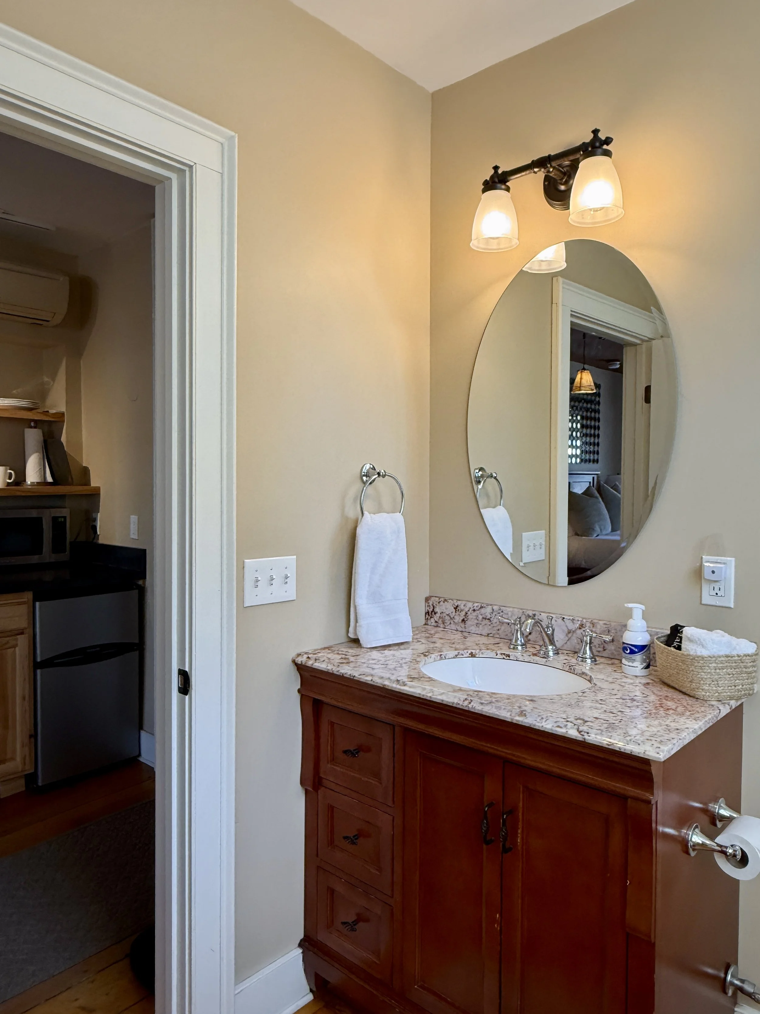 Bathroom in The Lounge with vanity, mirror and clean comfortable design