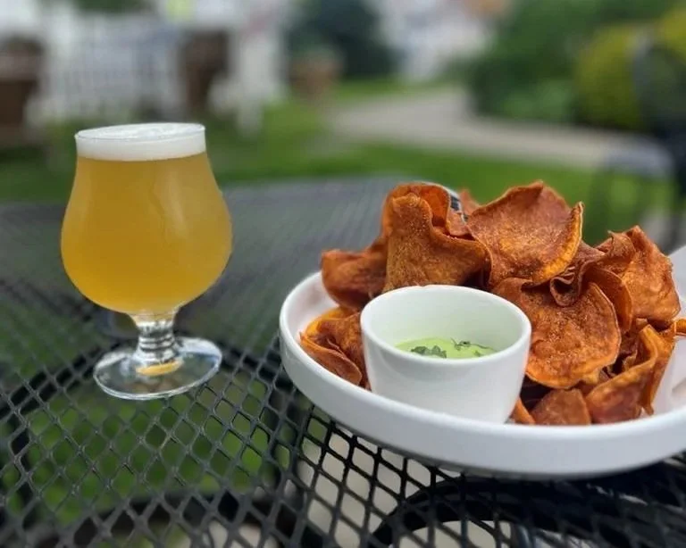 Craft beer and house-made chips served at Butler's Pantry in Stowe Vermont on outdoor patio table