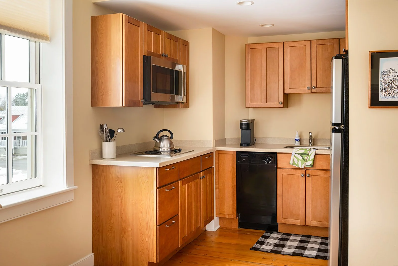 Fully equipped kitchen in Sarah's Suite Stowe, CT with wood cabinetry and modern applicances 