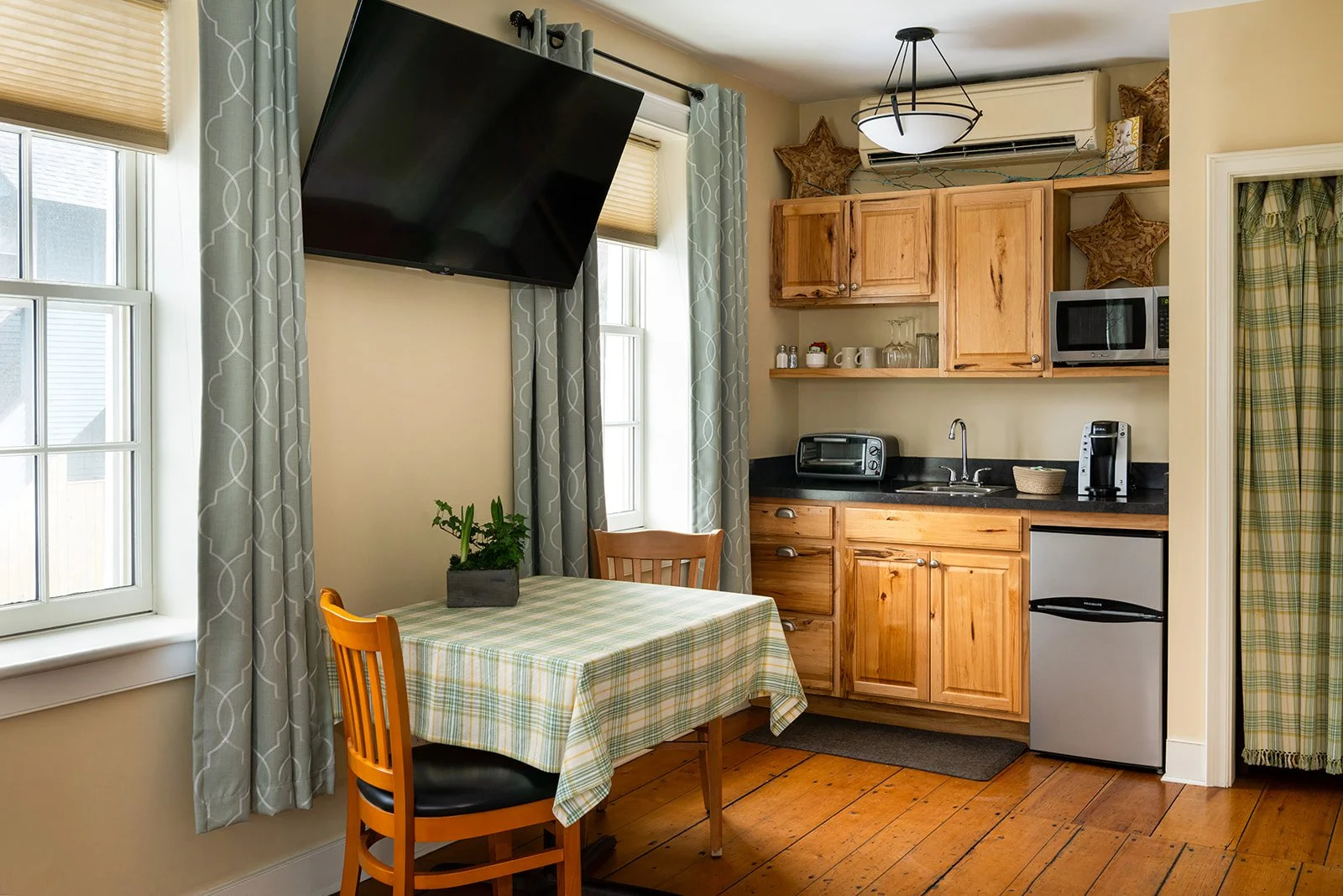 Kitchenette and dining nook in Parlor Suite Stowe VT with wood cabinetry and table for two
