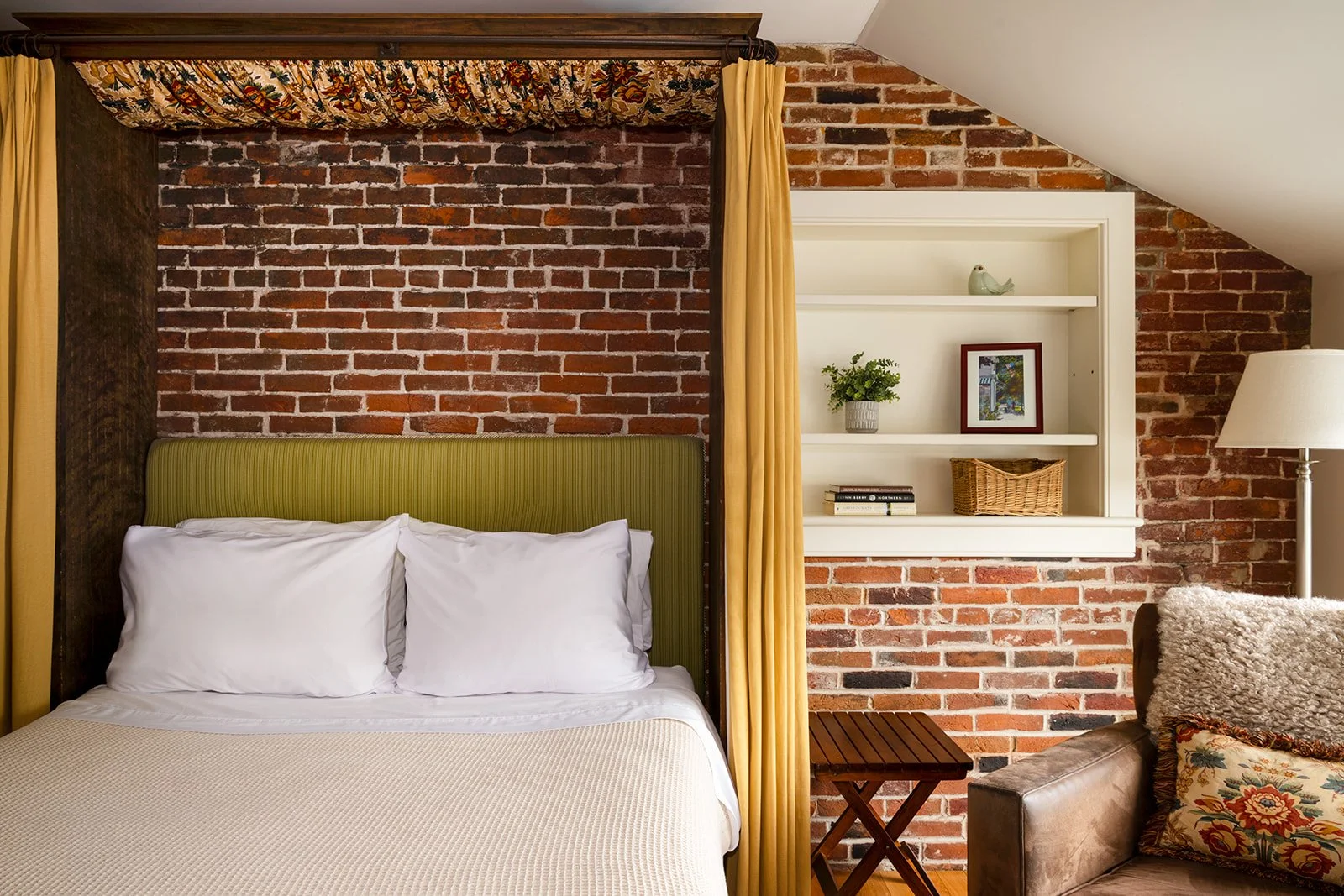 Murphy's Studio at Butler House Stowe featuring exposed brick wall, murphy bed and seating area