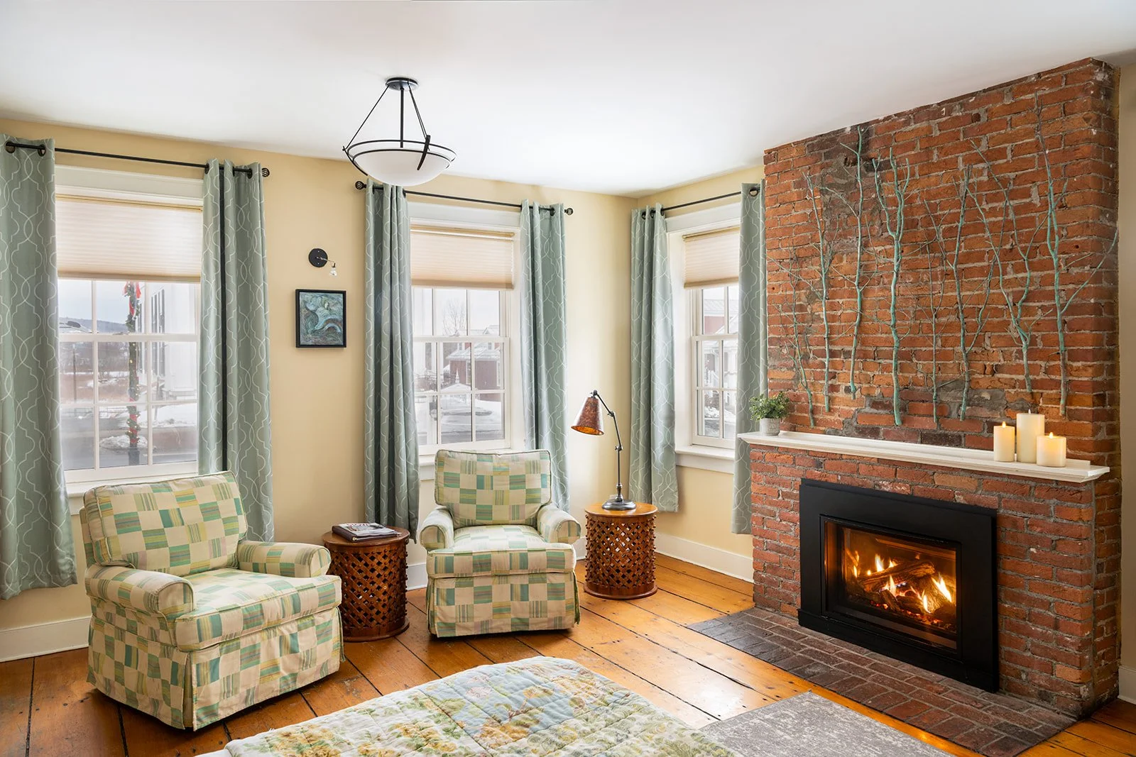 Parlor Suite at Butler House Stowe with original wide-plank floors, fireplace and historic living space