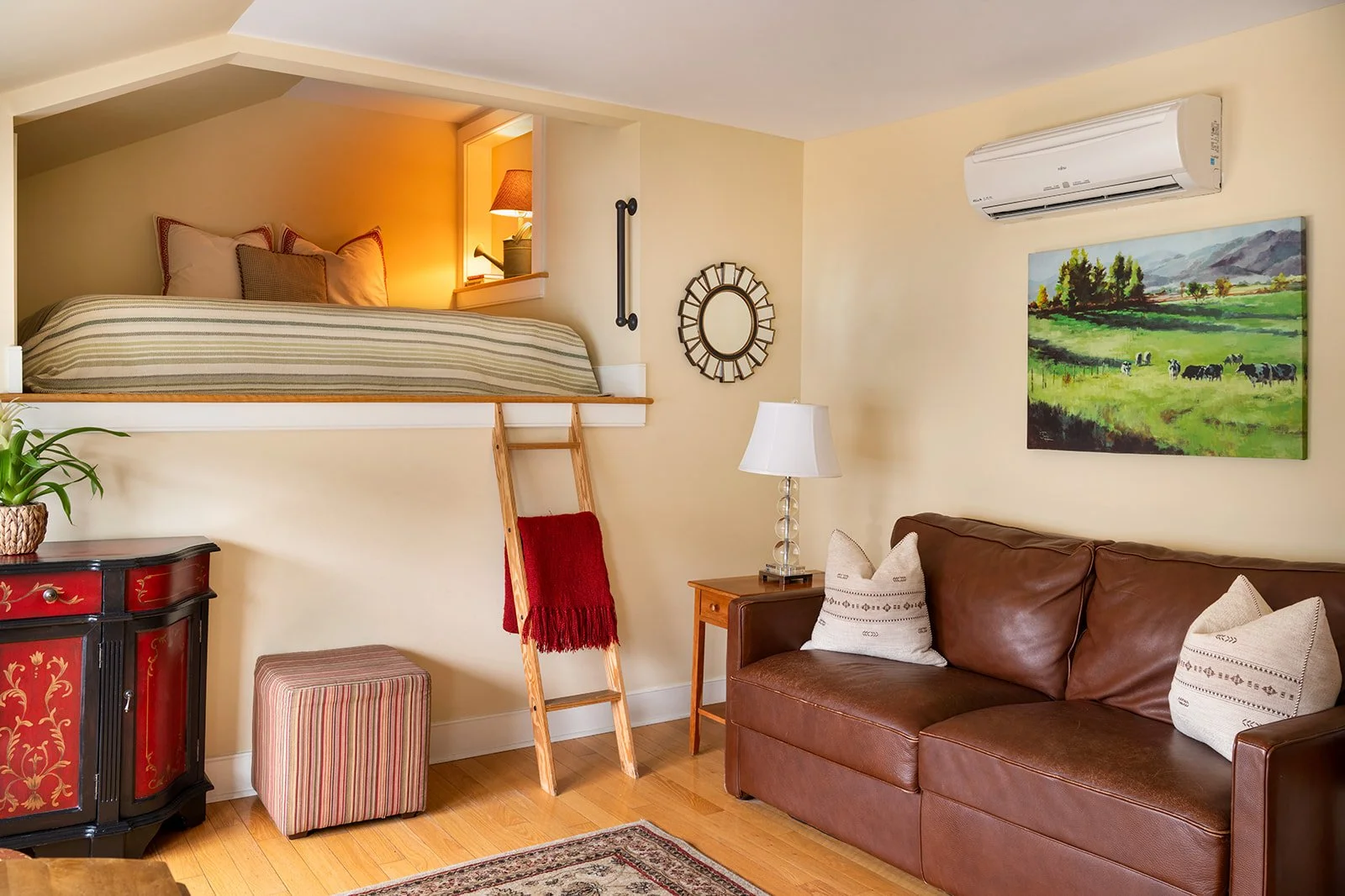 Zoe's Loft suite in Stowe Village with Ladder-access loft bed, cozy sofa and thoughtfully designed studio layout