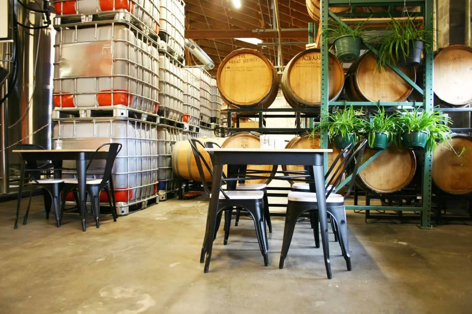 Inside Stowe Cider in Stowe Vermont with barrels, tanks and tasting area for craft beer