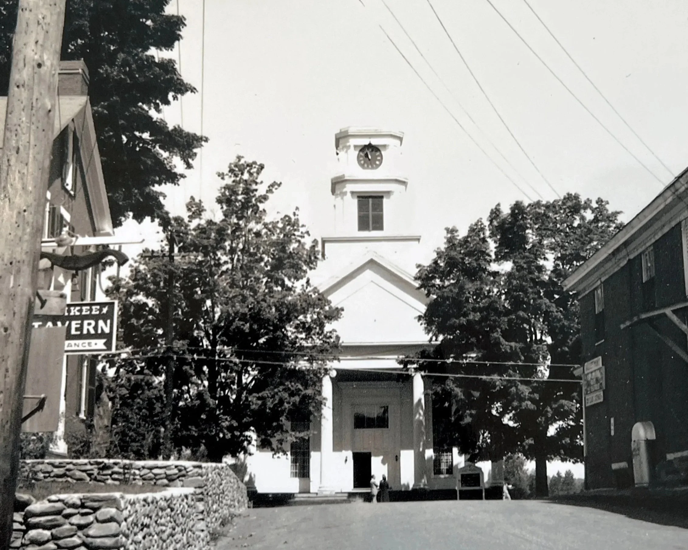 Historic image of Stowe Village church and surrounding buildings showing early town life in Vermont