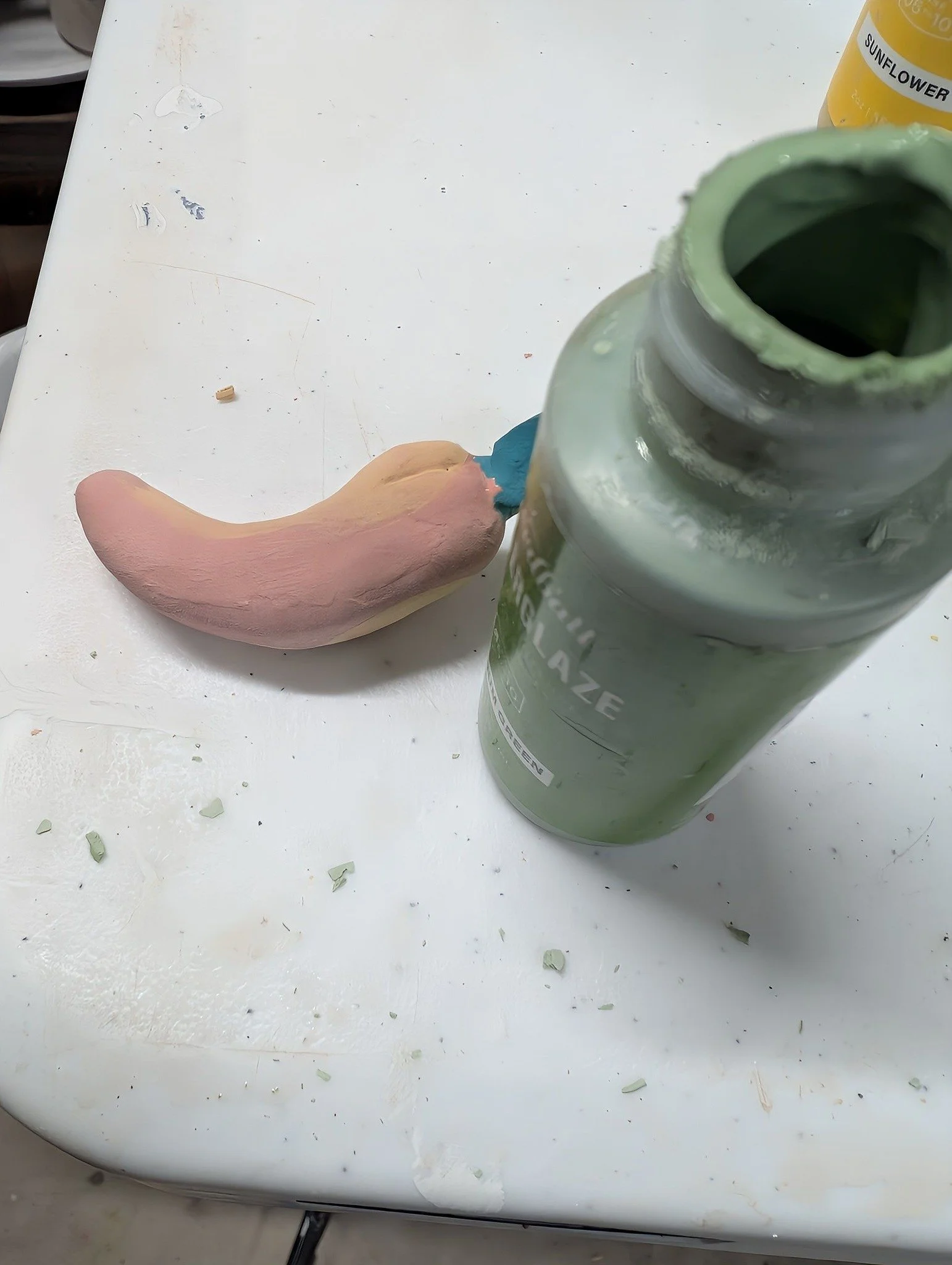 One thing I've come to hate in my pottery studio is glaze crumbs that fall from the bottle when you twist the lid off!

Ugh! It makes such a mess and goes everywhere, even into nearby pots that have wet glaze on them--yucky and difficult to remove. 
