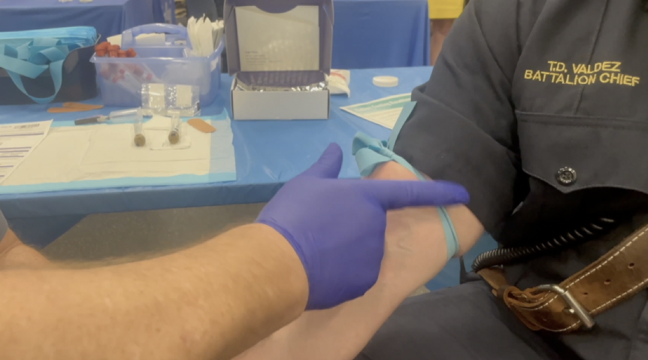 Someone receiving a vaccination shot in an indoor setting.
