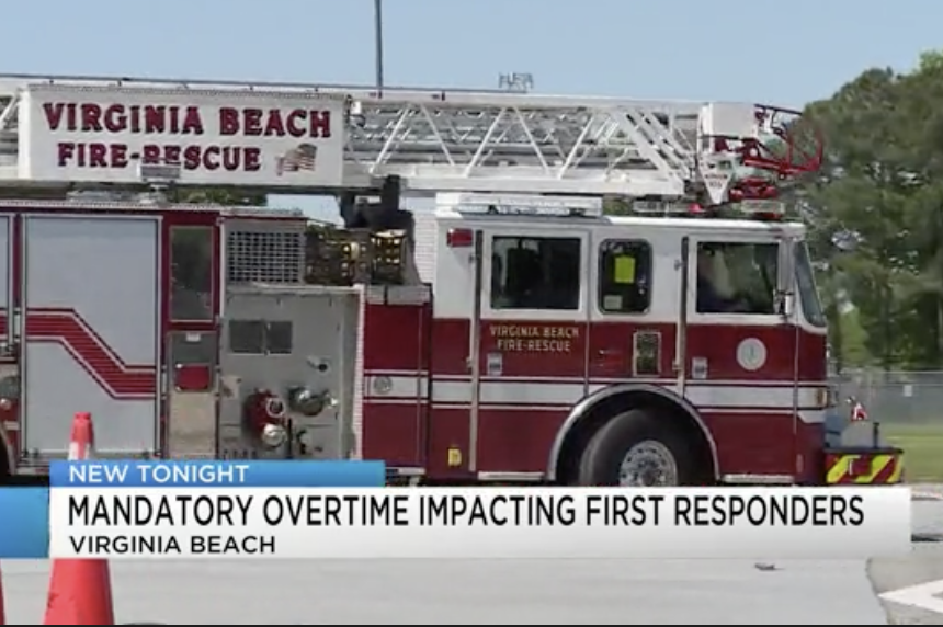 Virginia Beach fire rescue truck with a ladder on top, parked at a scene with caution cones, in Virginia Beach.