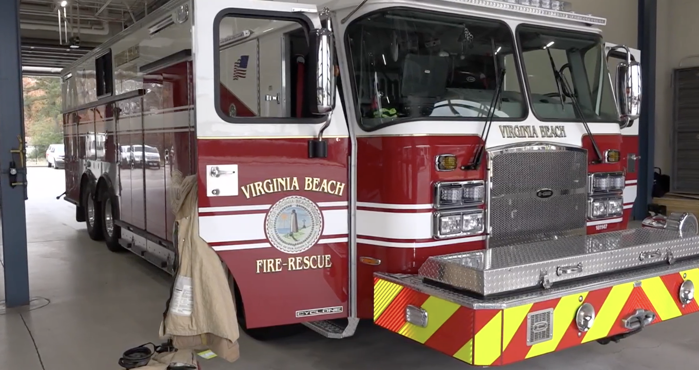 Red Virginia Beach fire rescue truck parked inside a fire station garage.