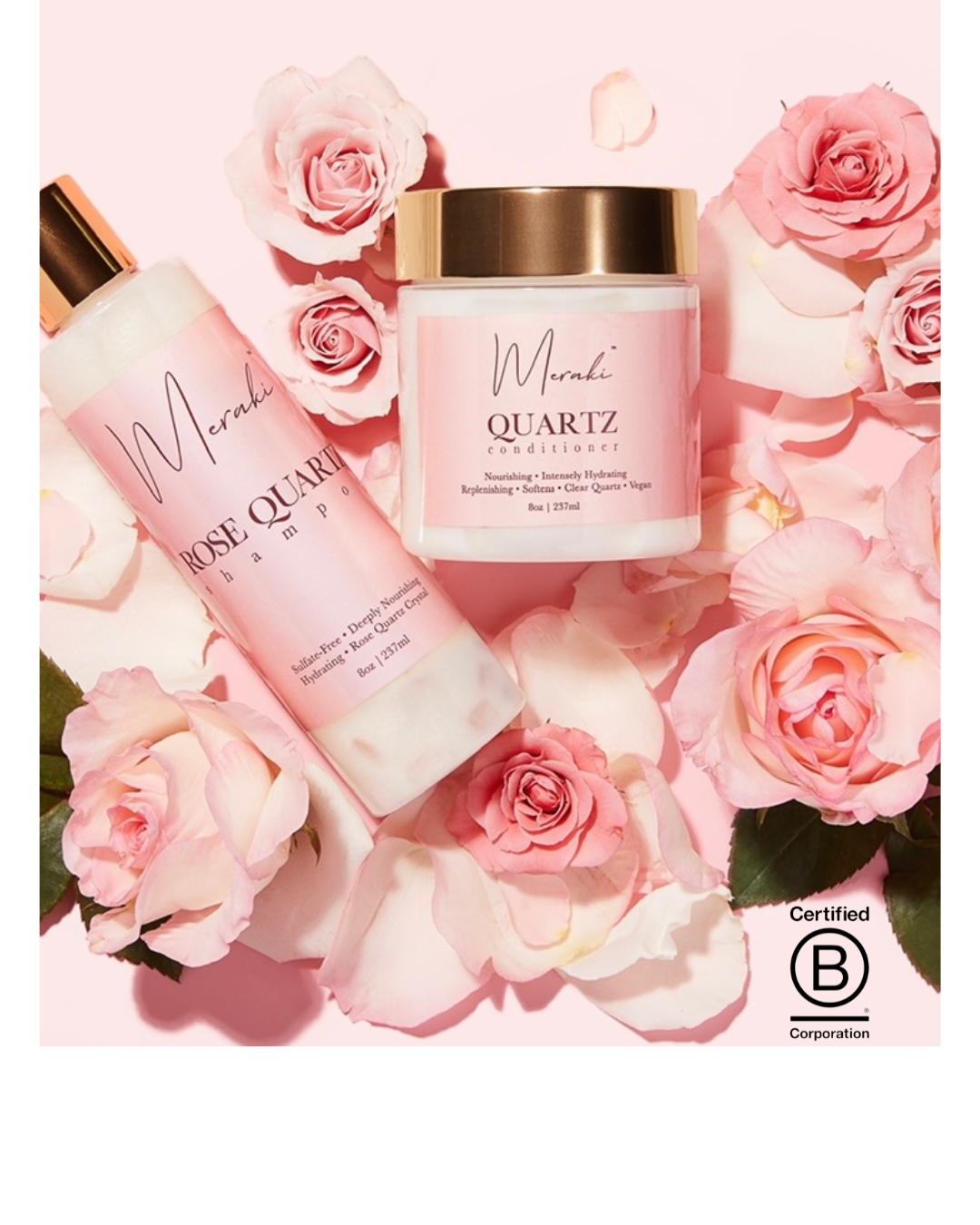 Bottle of Meraki Rose Quartz shampoo with pink label and gold cap, placed on a white surface next to a piece of rose quartz crystal.