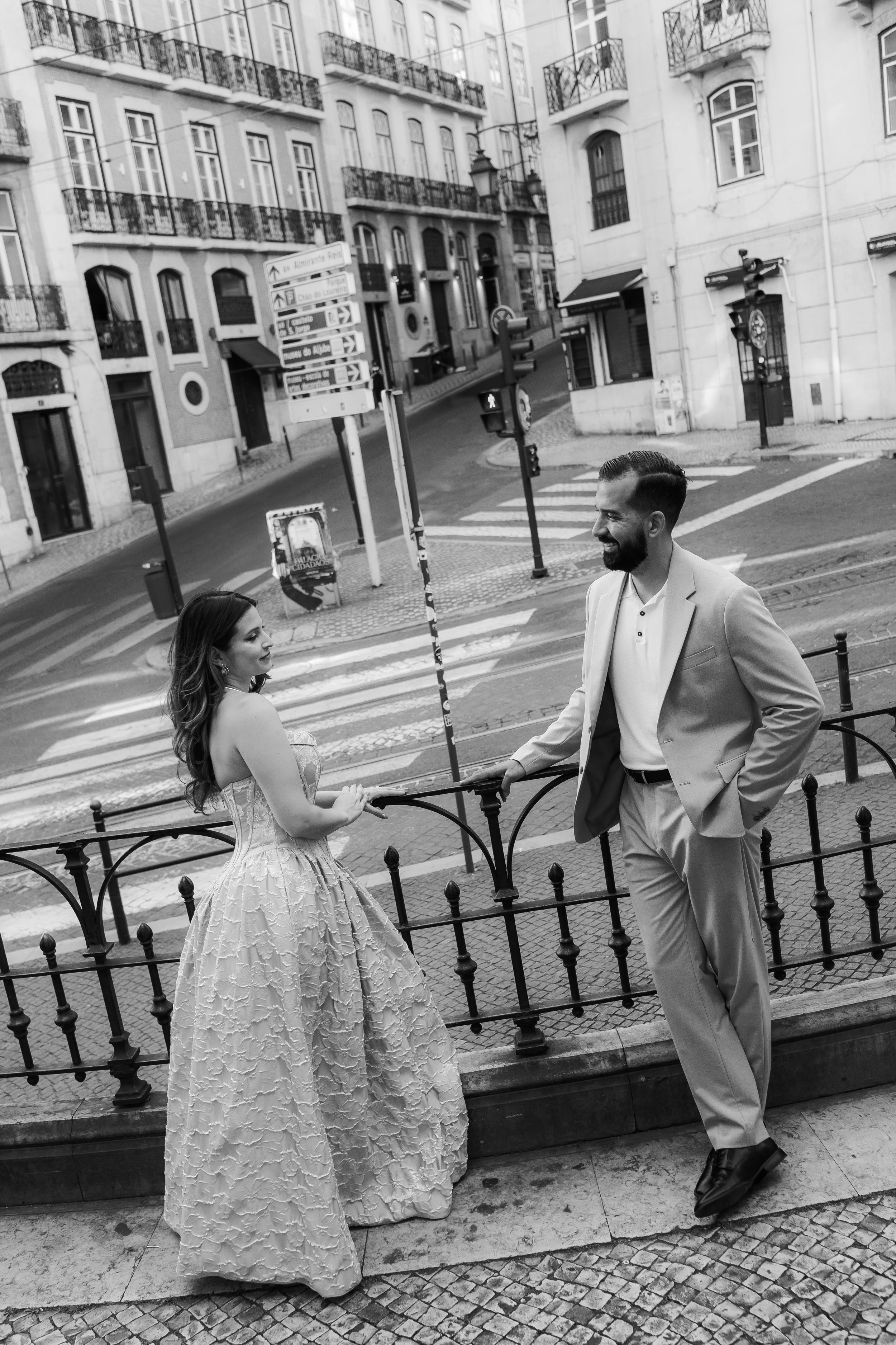 Couple during an elopement in Lisbon standing in a city street setting captured in black and white
