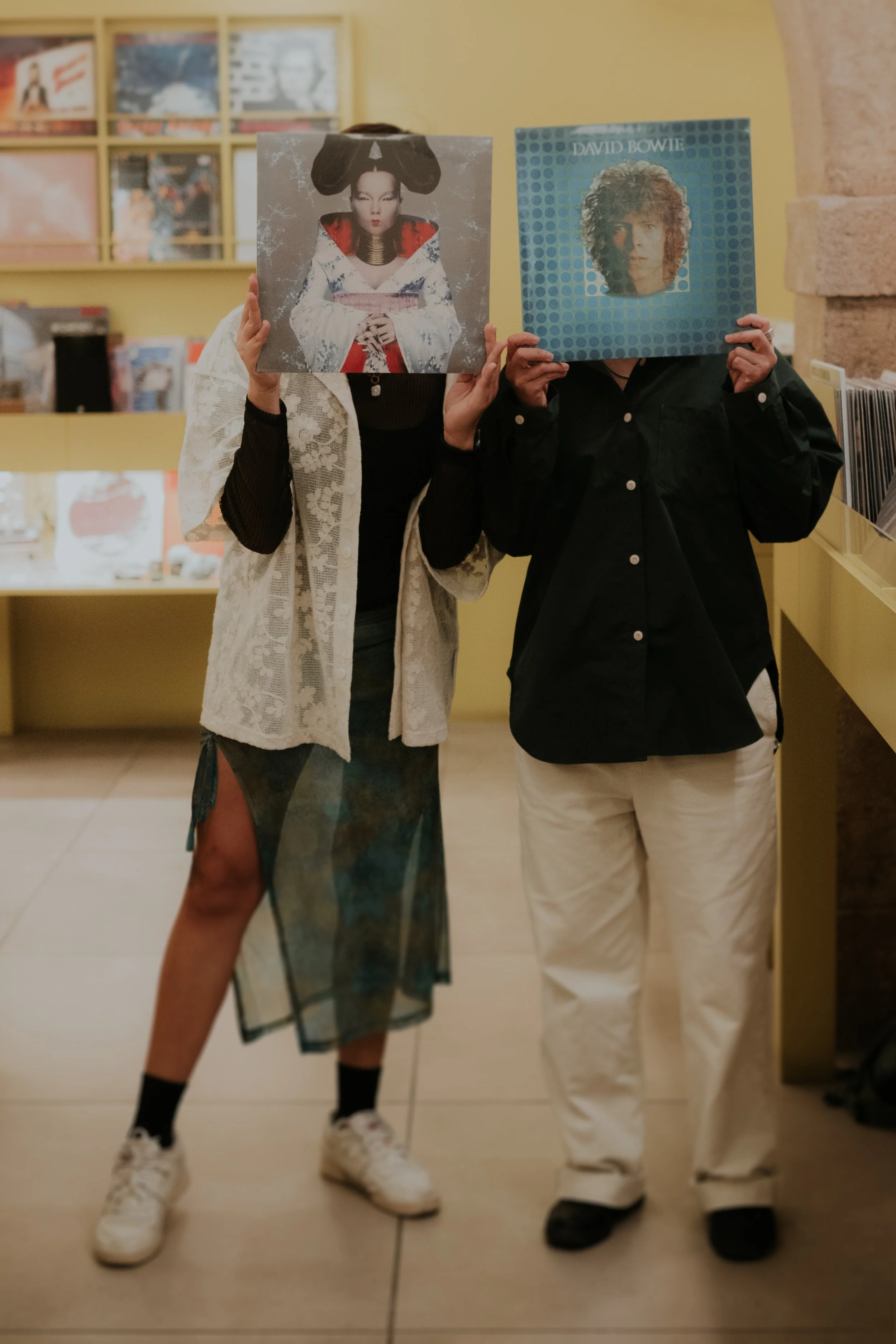 Couple holding vinyl records in a playful and creative lifestyle photo session