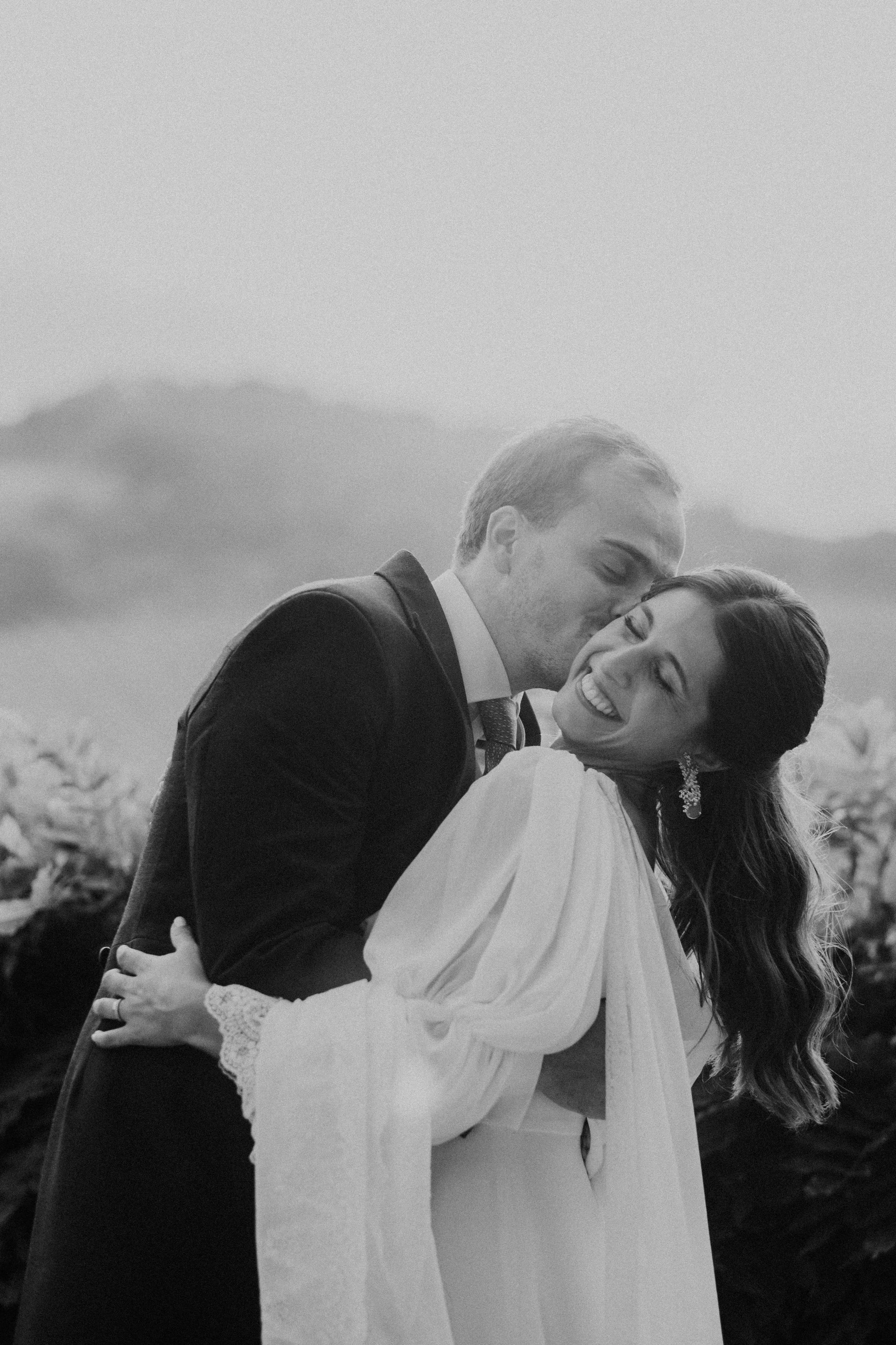 Bride and groom sharing an emotional embrace during a wedding in Portugal captured in black and white