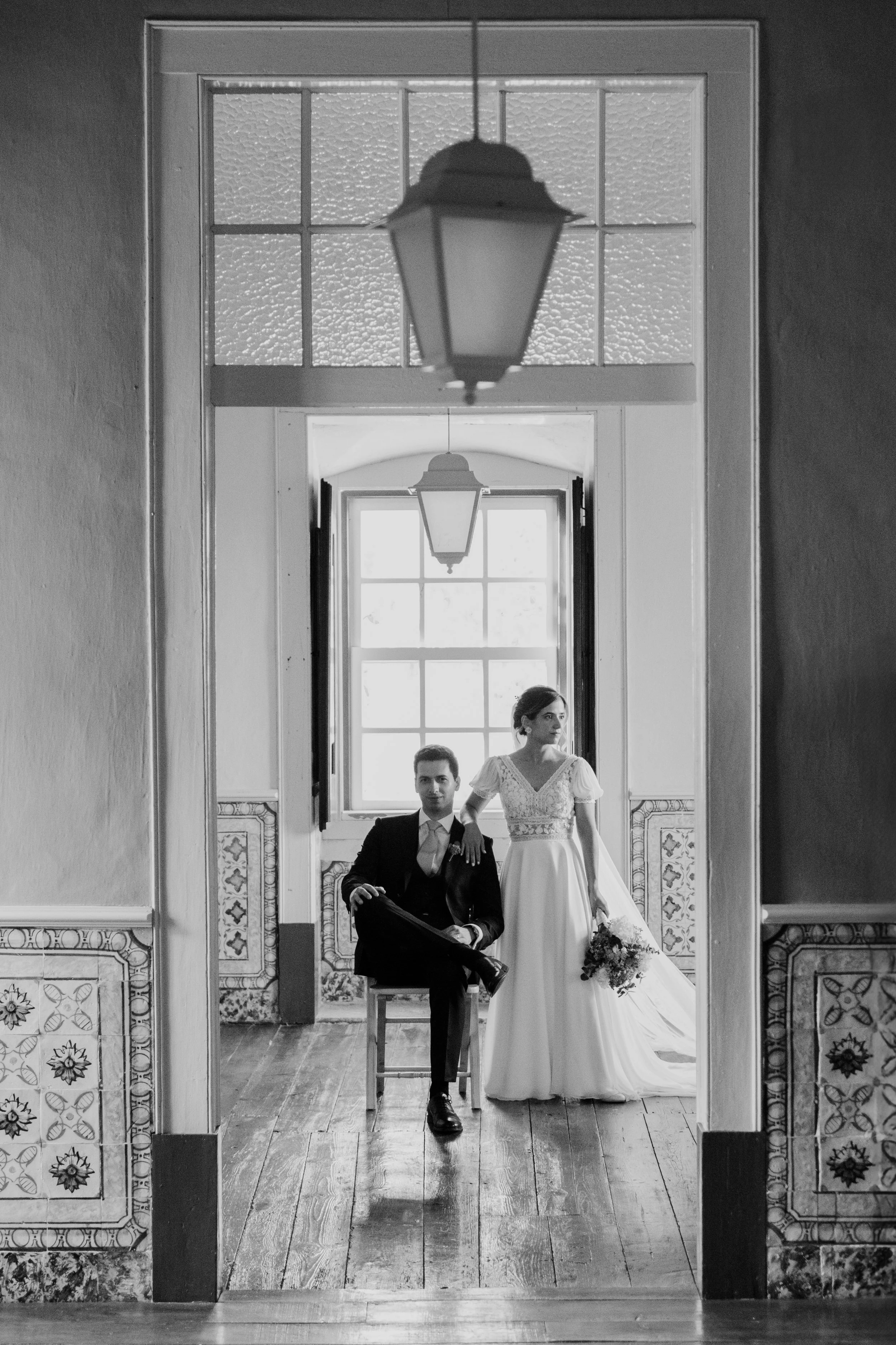 Bride and groom in a classic architectural interior during a wedding in Portugal captured in black and white