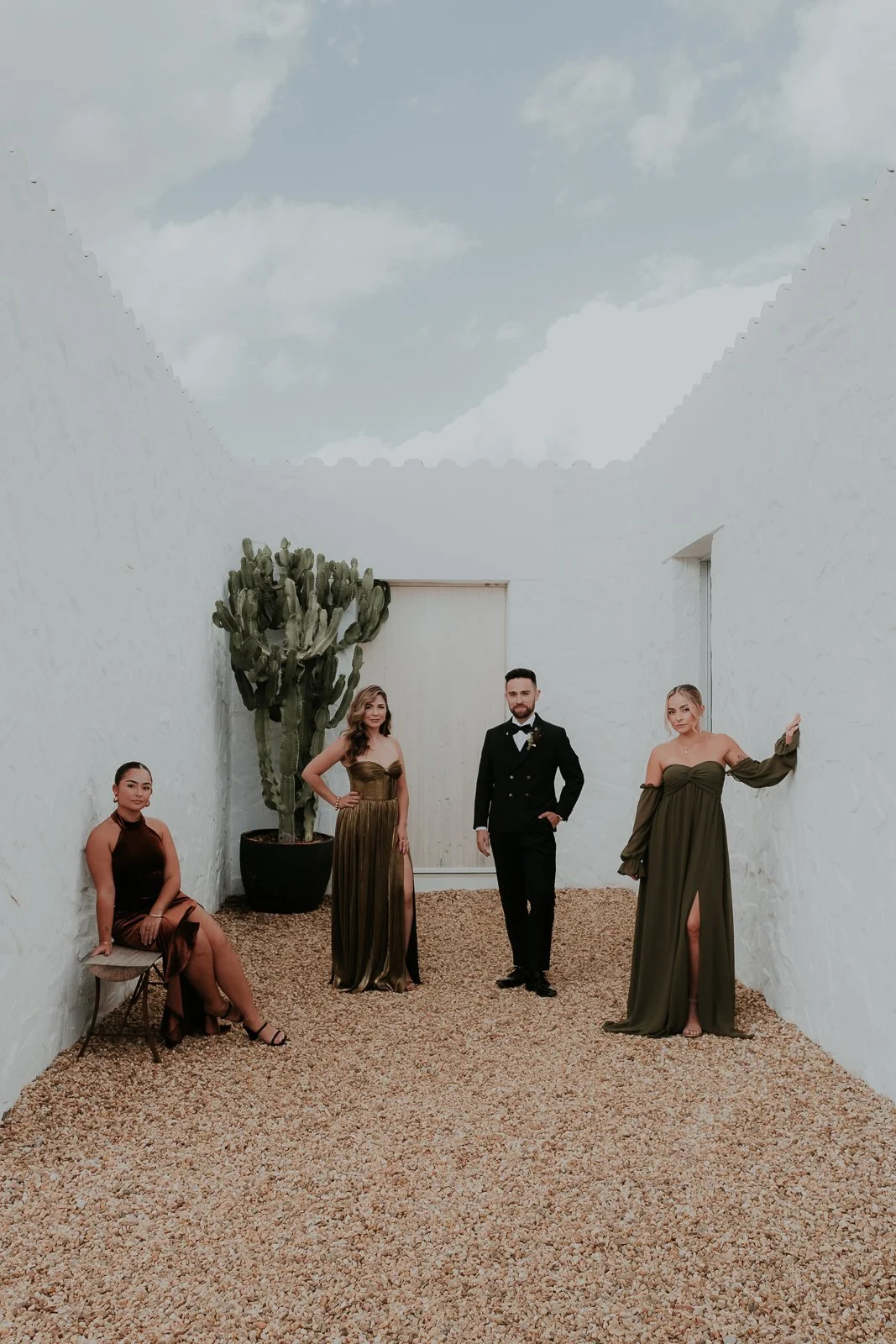 Bridal party standing in a minimalist architectural setting during a wedding in Portugal
