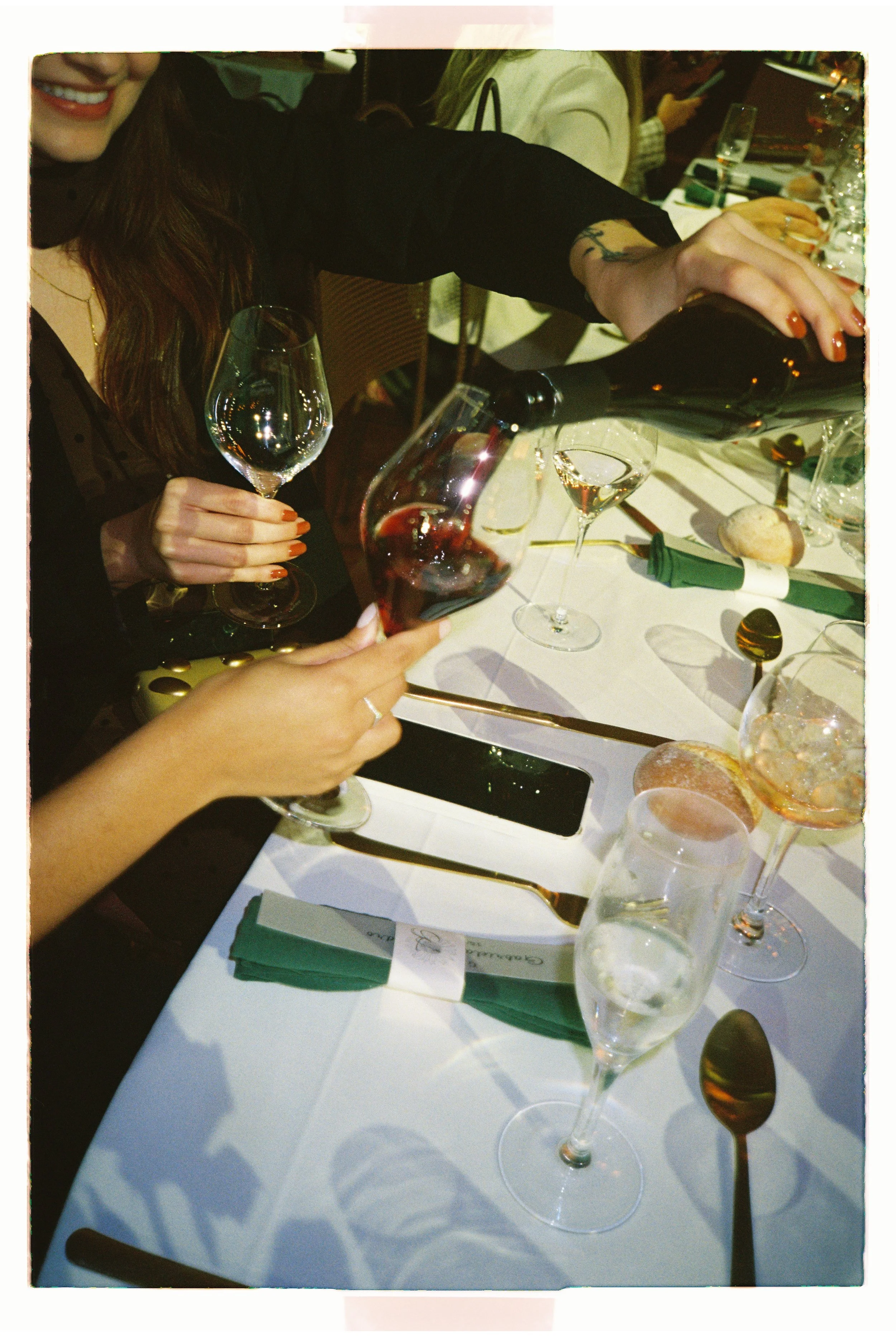 Guests toasting with wine glasses during a wedding reception in an intimate setting