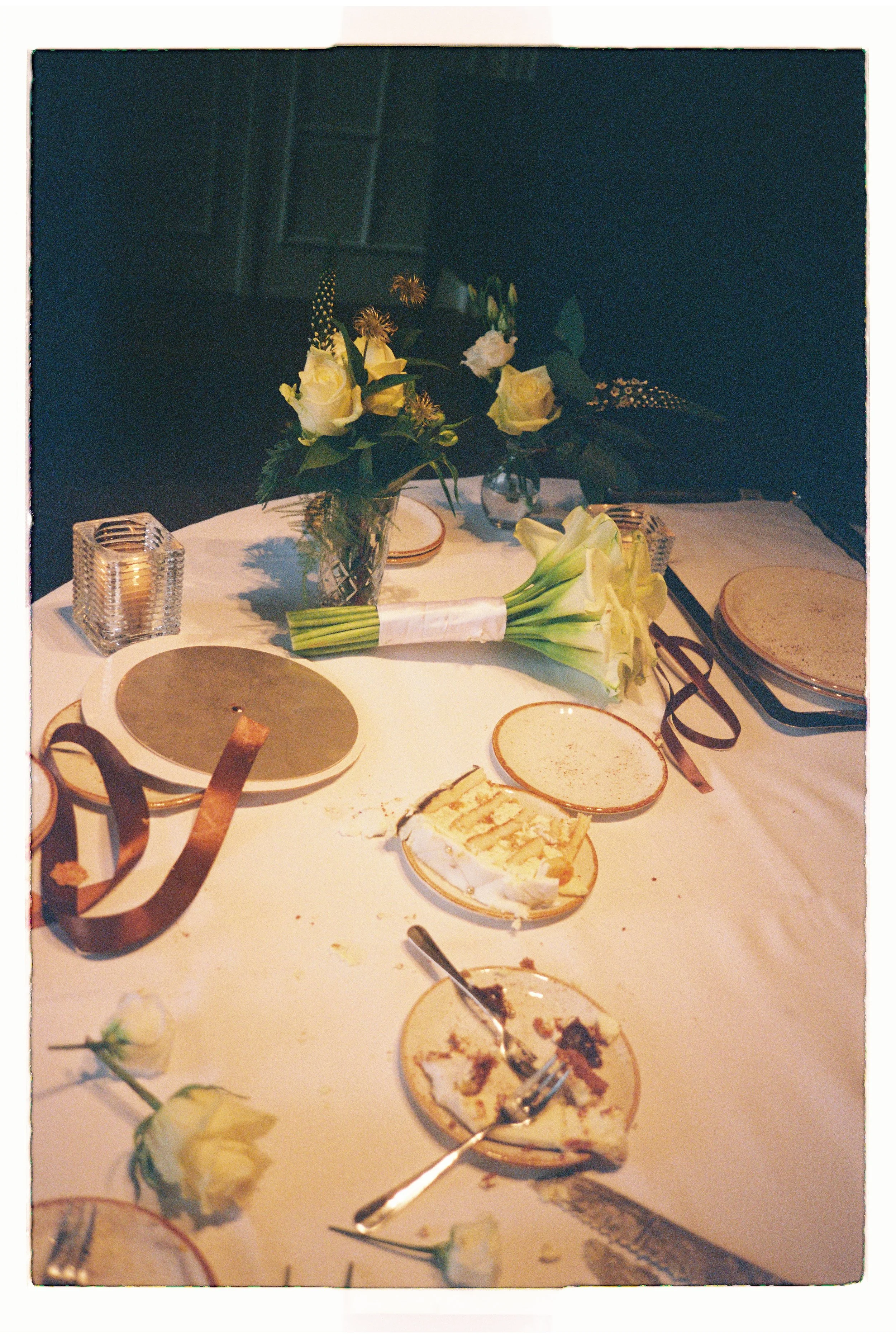 Intimate wedding table setup with candlelight and floral details in a refined setting