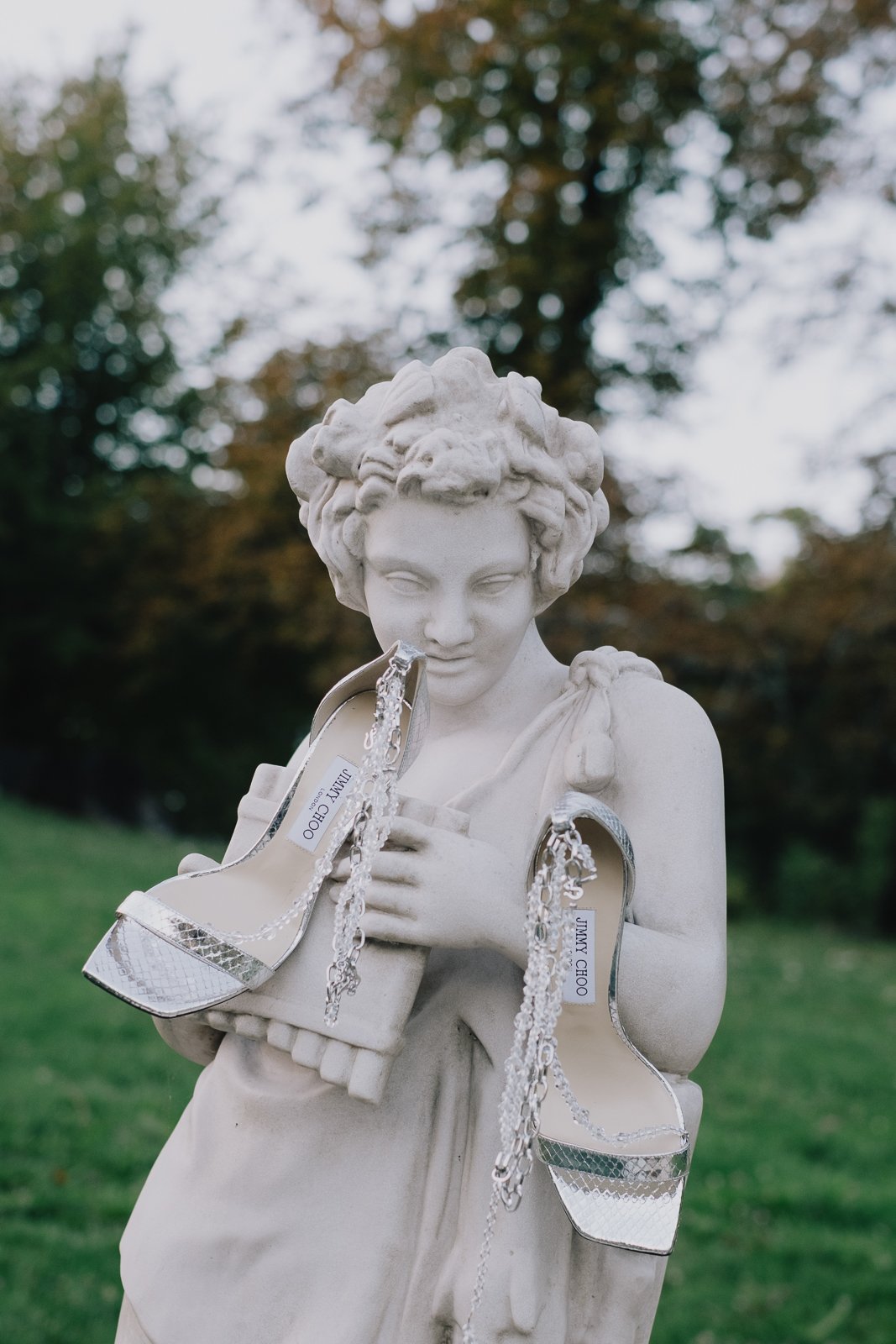 Classical statue detail captured at a wedding location with artistic composition