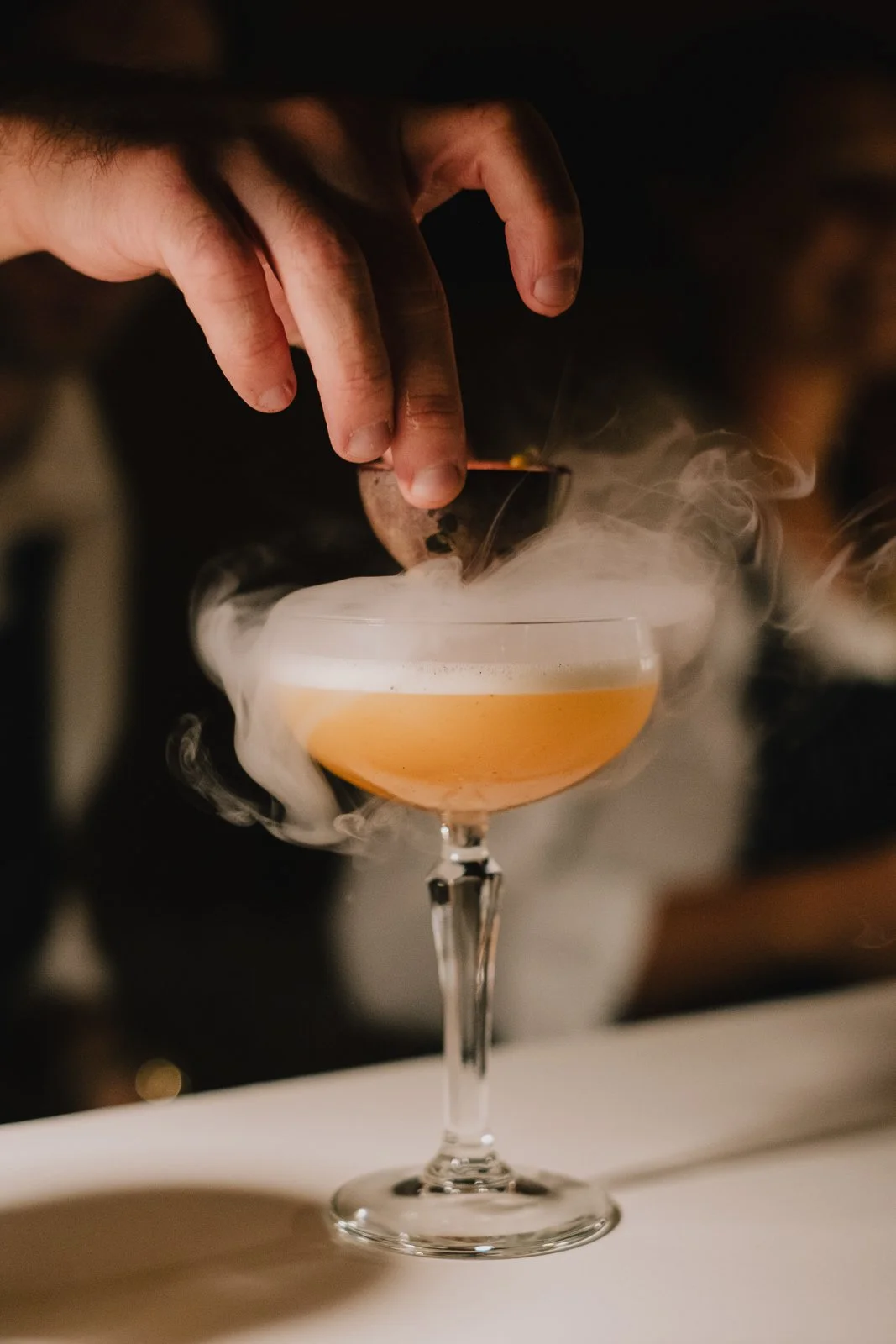 Close-up of a cocktail being served during a luxury wedding celebration