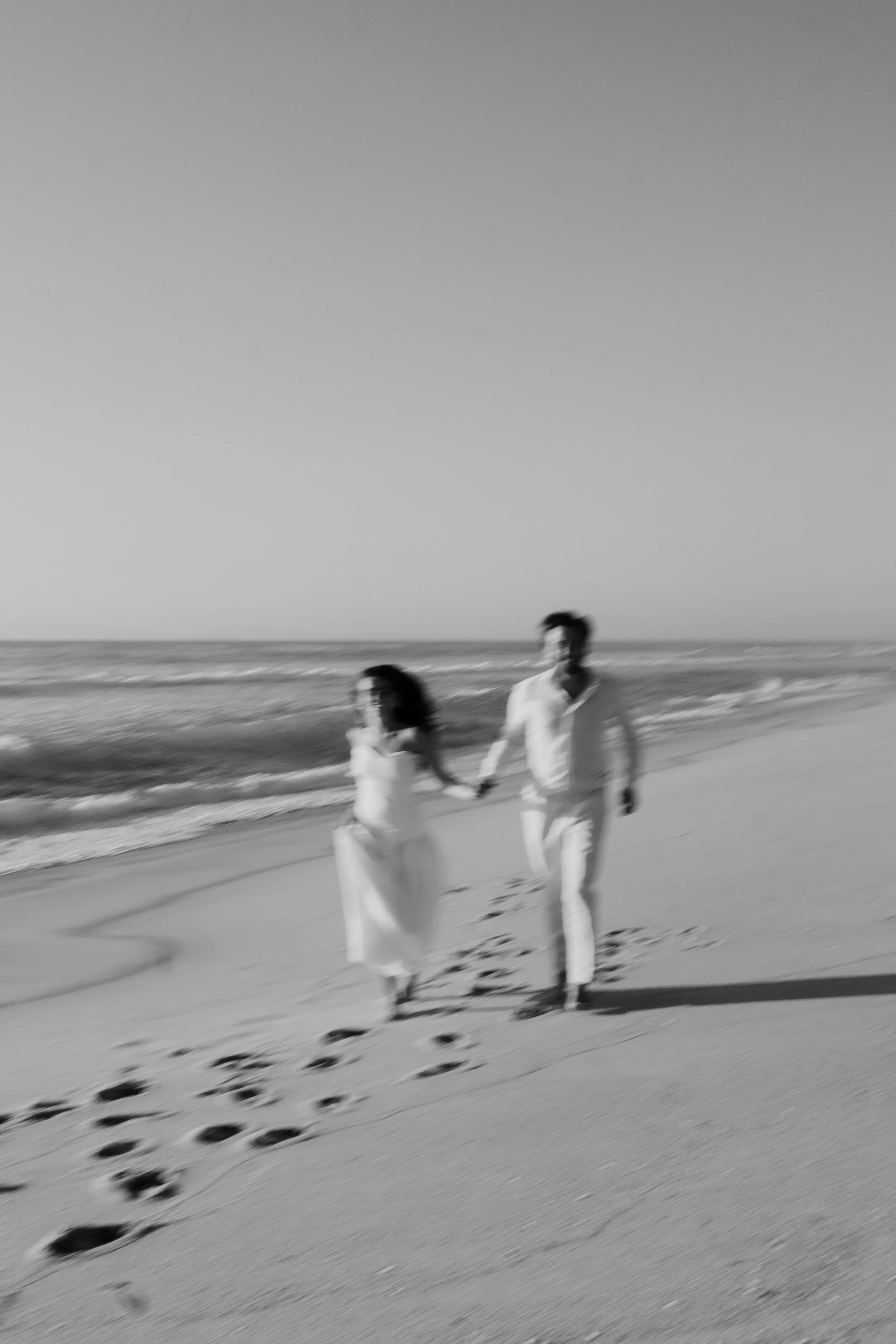 Couple walking together along the beach during a couple session in Portugal