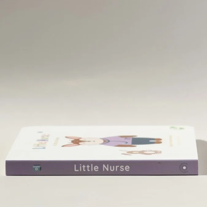 Cover of the children's book titled 'Little Nurse' with an illustration of a girl in a purple dress and brown hair on a plain surface