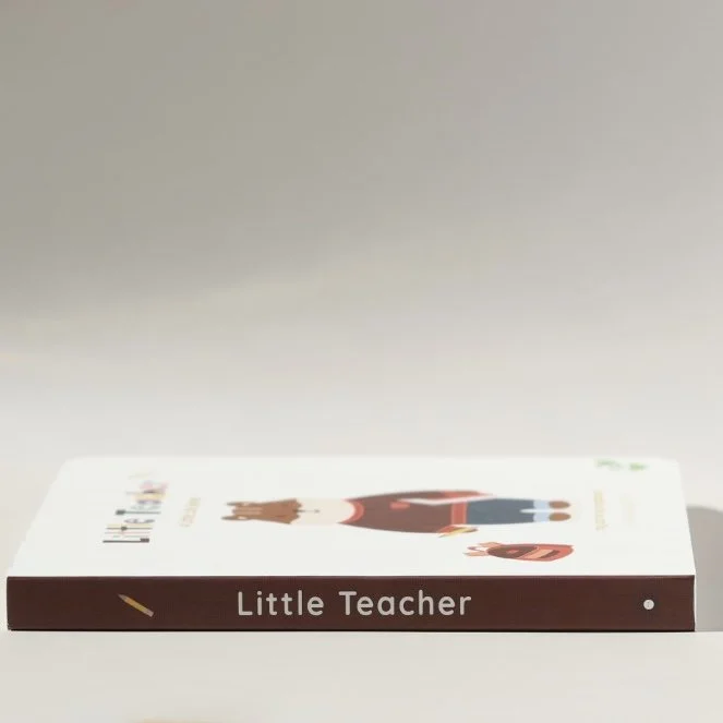 A children's book titled 'Little Teacher' lying flat on a white surface with a plain light gray background.