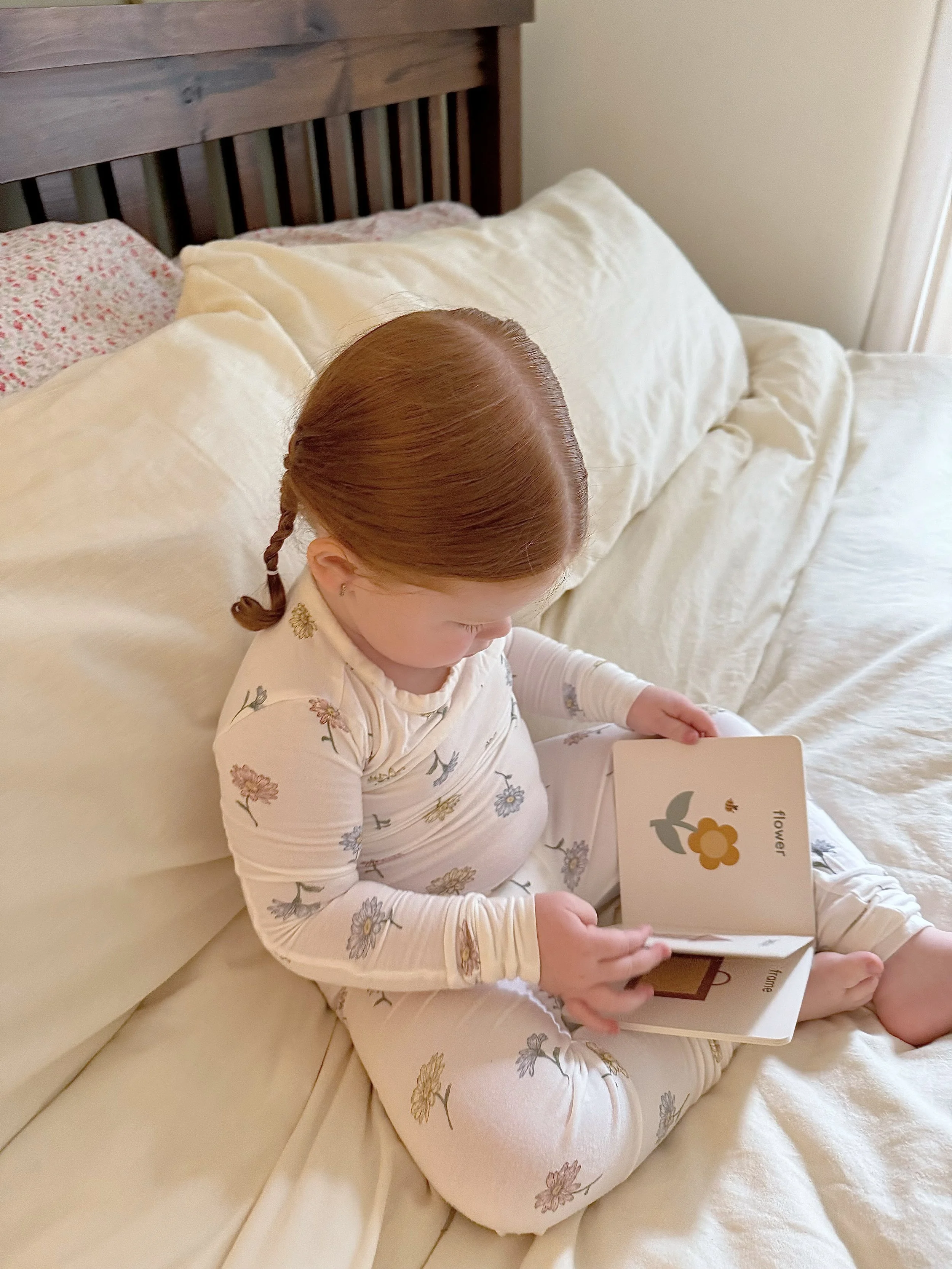 young child reading a Sunshine & Poppies Press Little Life Series book featuring gentle colors and forest animals.